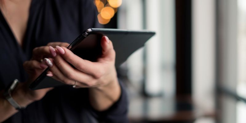 A Malaysian woman with a tablet, checking inventory