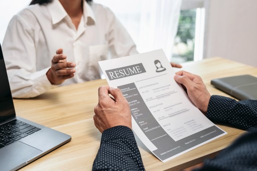 man holding resume in a meeting