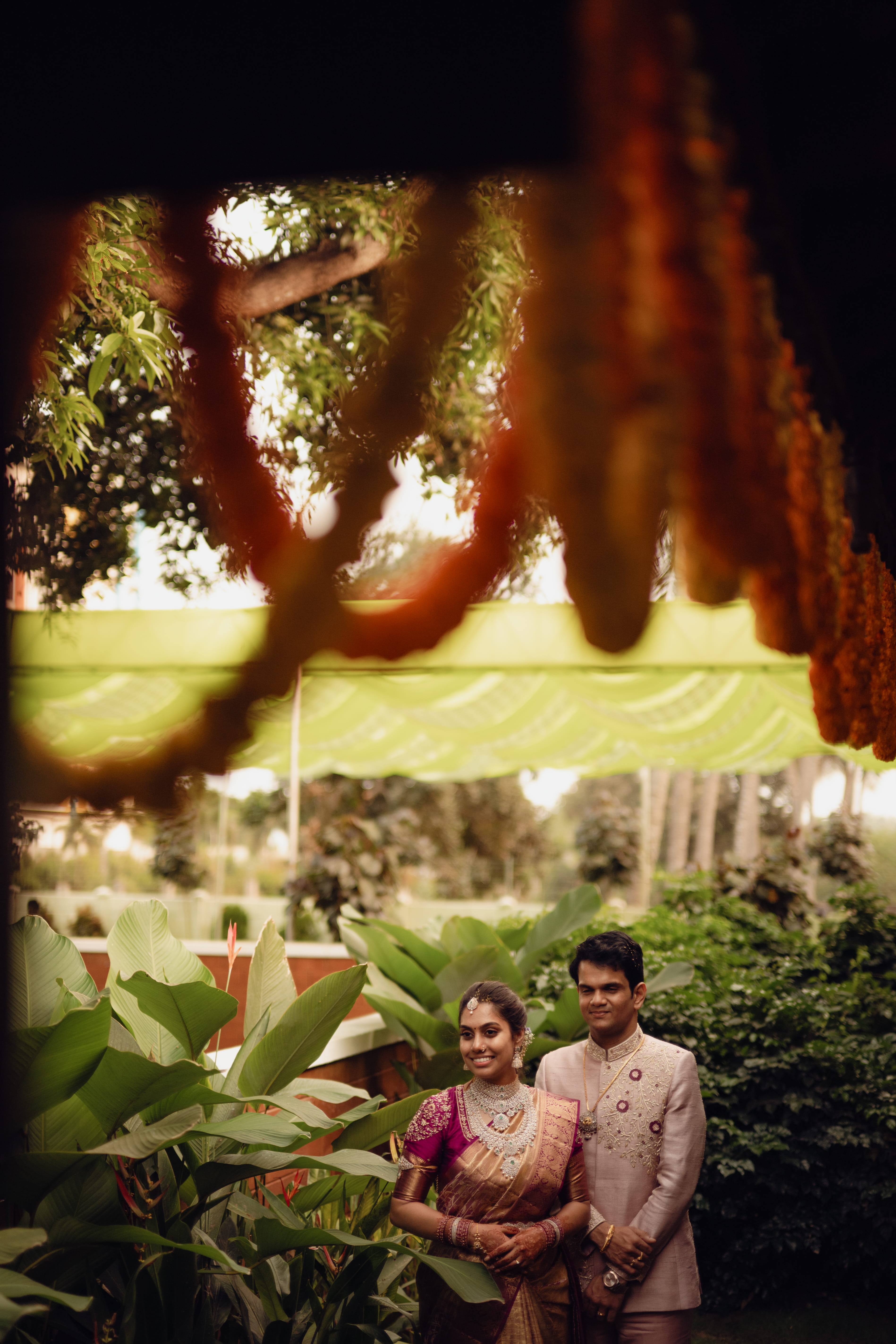 Engagement and blessing ceremony photo collage with floral backdrop, couple in ivory and pink traditional wear, by Wow Makers wedding photography in Hyderabad, India.