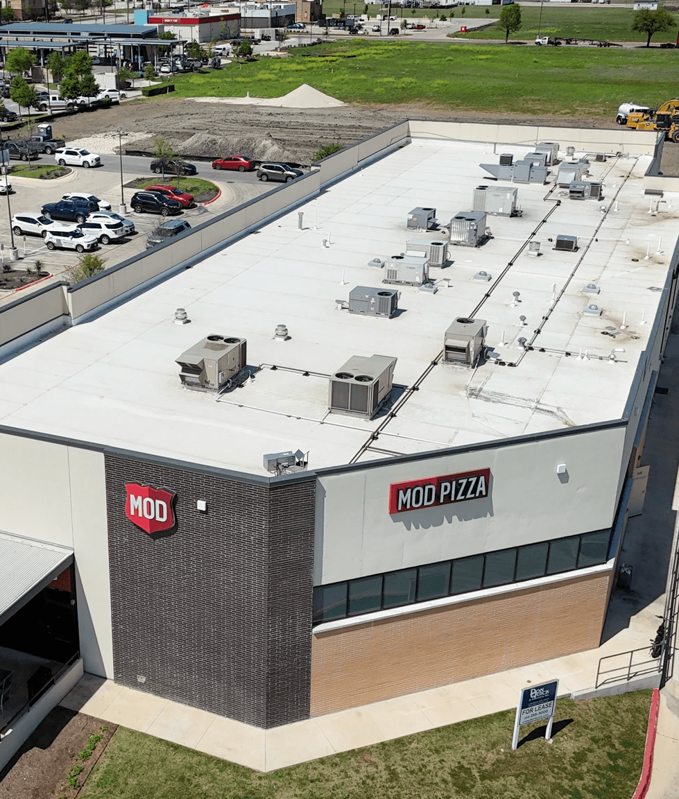 White commercial roof with ac units
