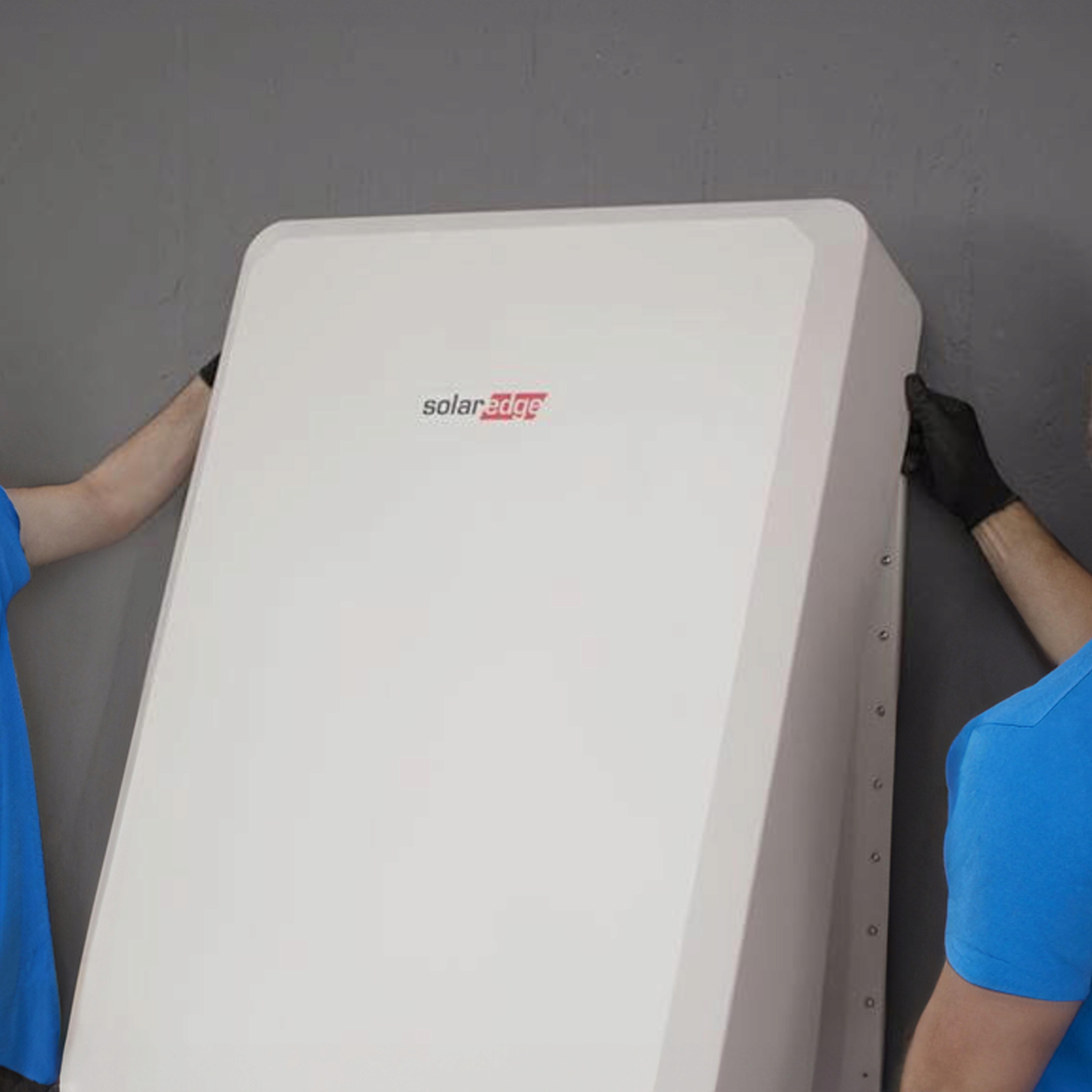 A Tesla Powerwall 3 mounted on the wall on the inside of a garage.