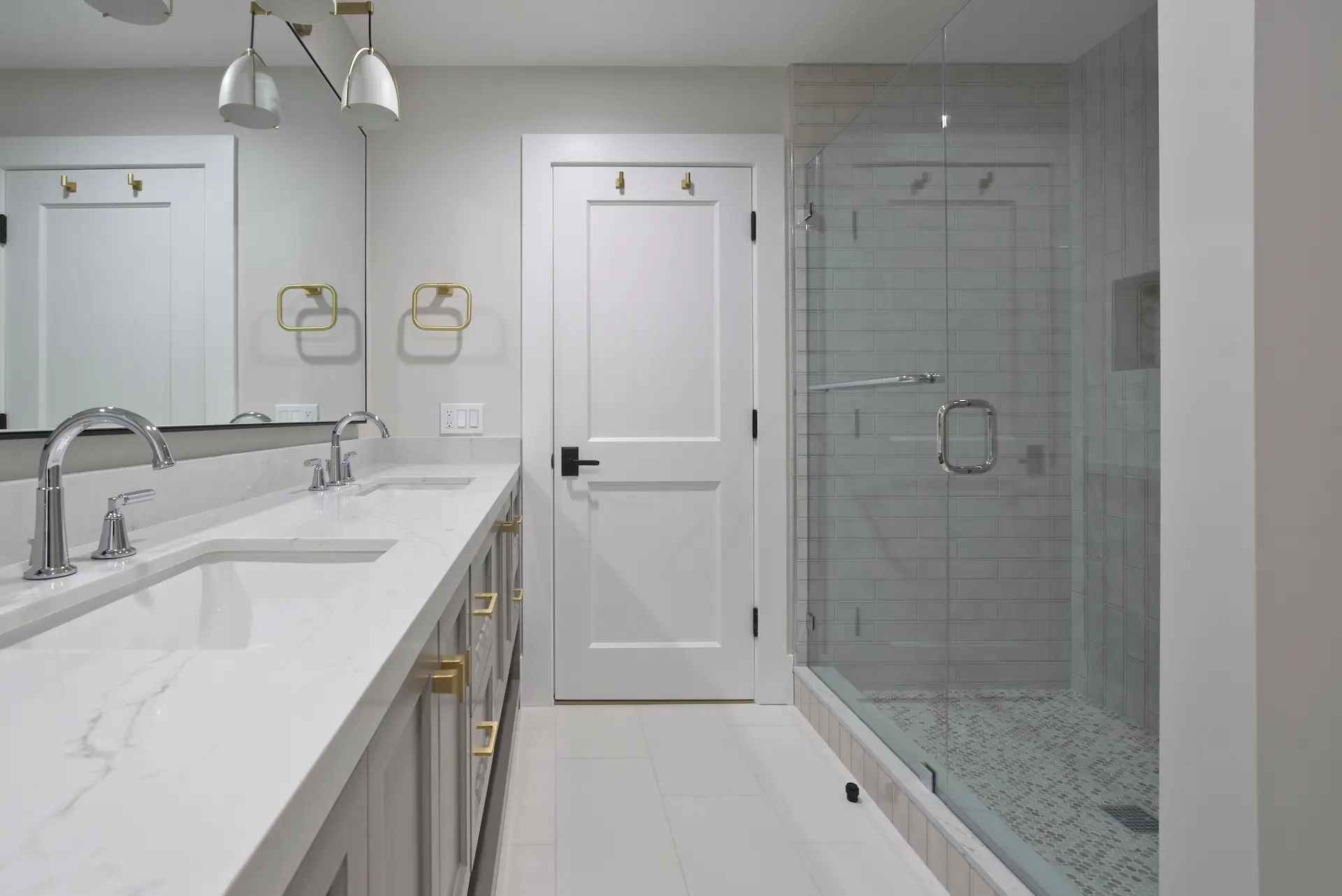 Wide shot of the Jack and Jill bathroom, showcasing a practical yet stylish shower and double vanity setup, perfect for shared spaces in the Dana Point Full Remodel. Photo by Todd Huge.