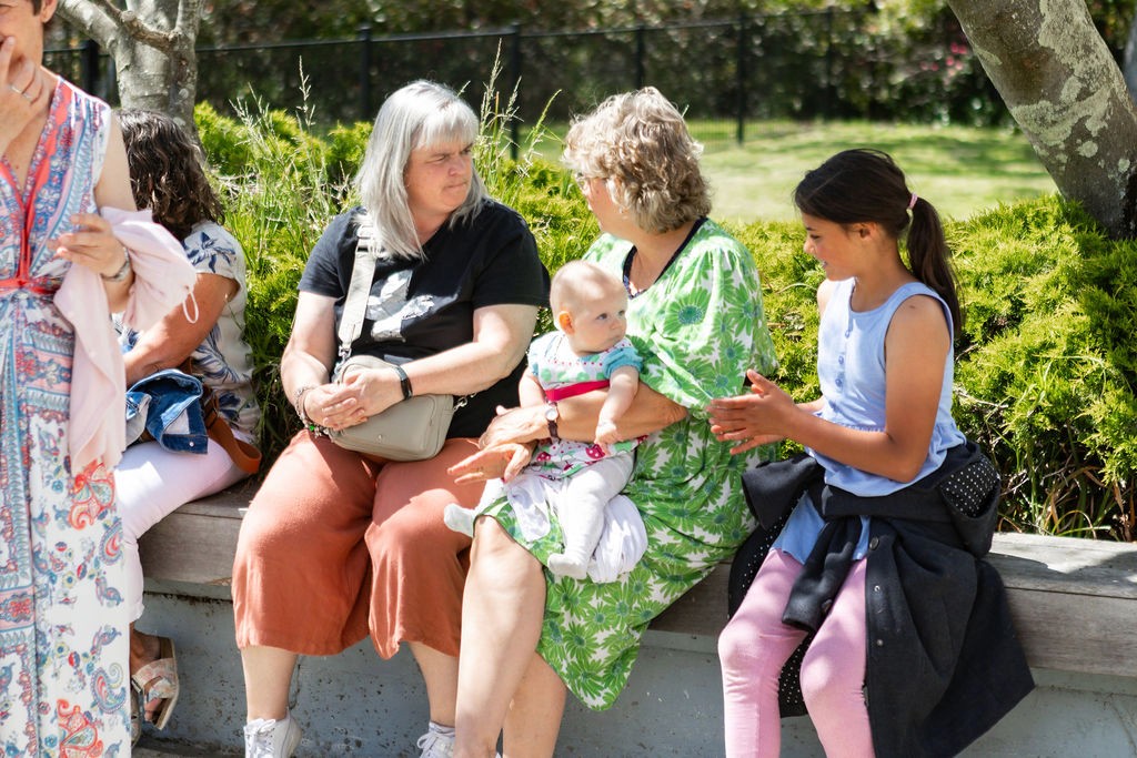 three men and one woman laughing during daytime