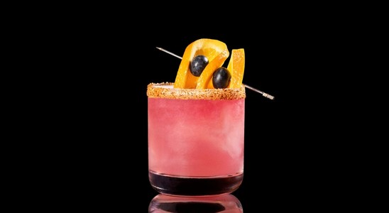 A closeup of a Blueberry NEFT-A-Rita  drink against a dark background.