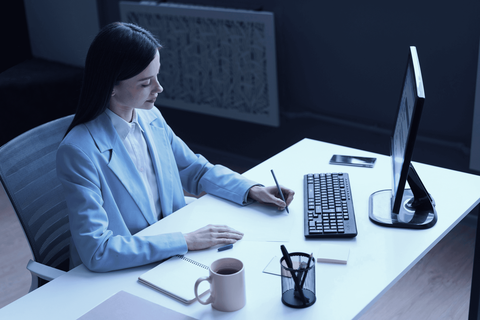Aerial view of a suburban neighborhood with houses, roads, and a lake, captured during the daytime.
