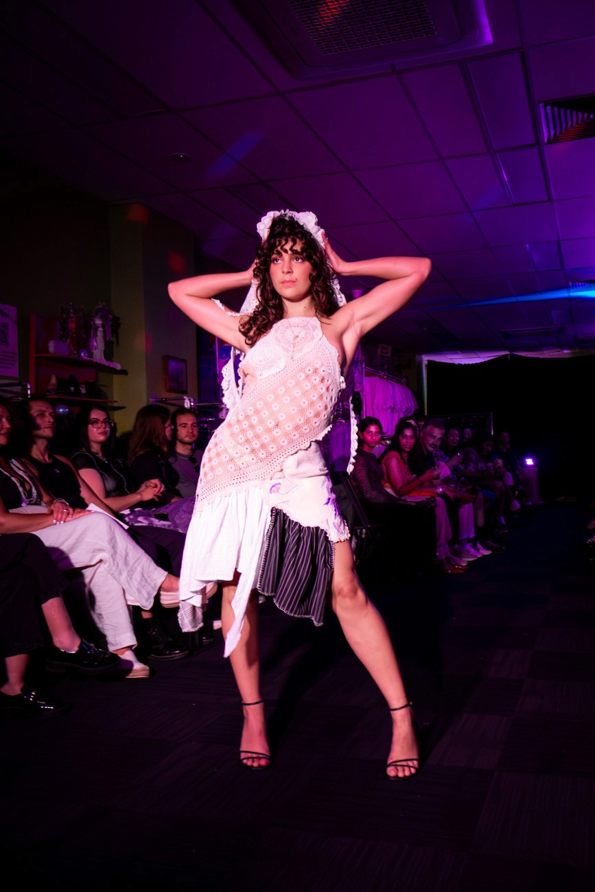 female model on runway wearing a reworked lace dress