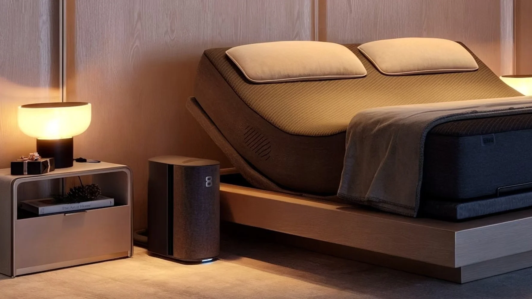 Bedroom with an adjustable bed, two pillows, and warm bedside lighting