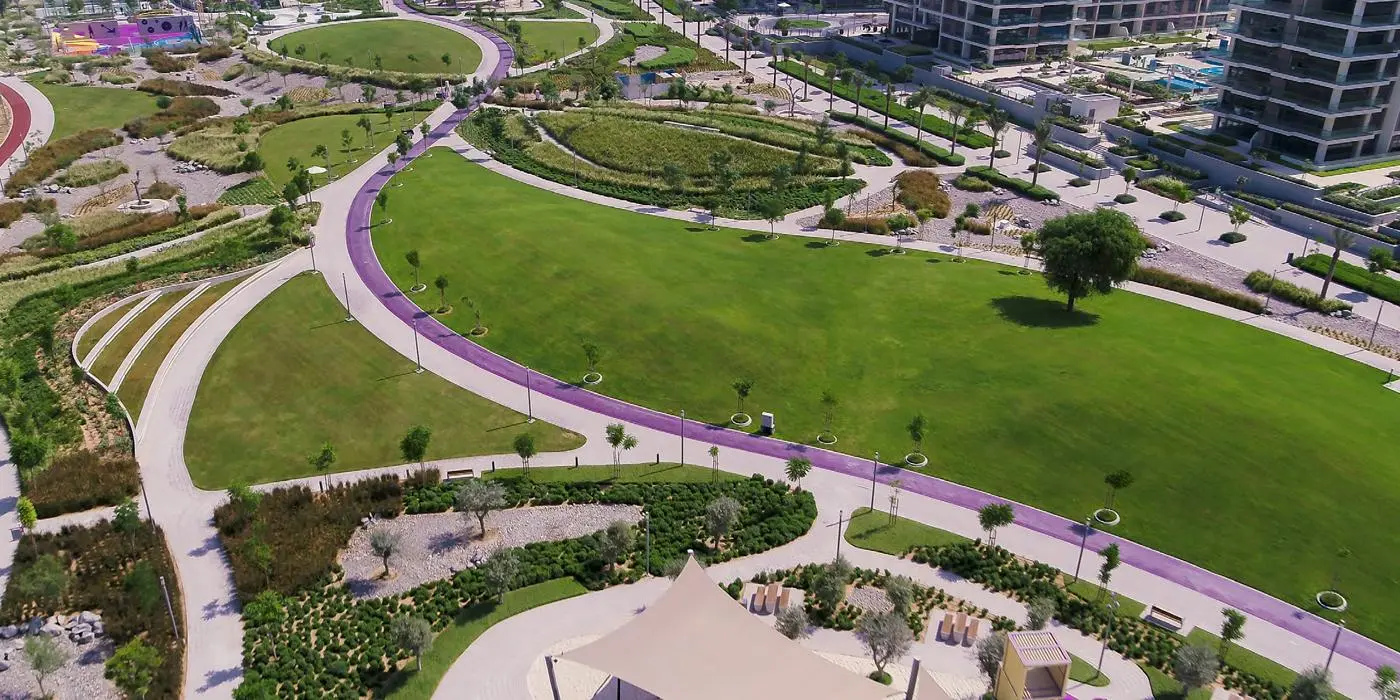 Modern row houses in Dubai Hills Estate with flat roofs, brick sidewalks, and landscaped front yards in a calm suburb.