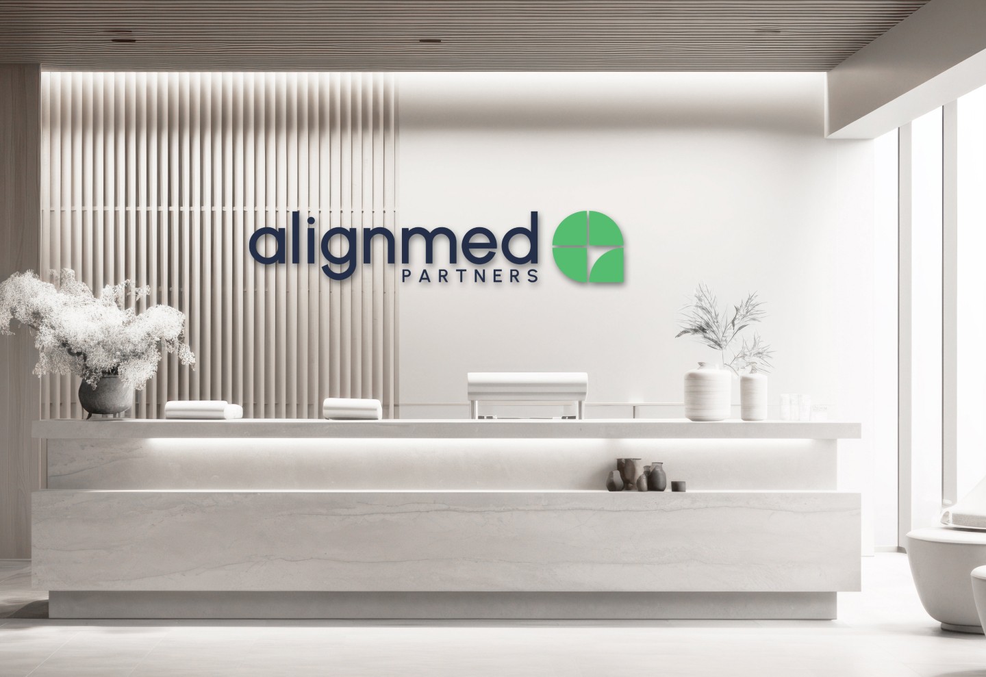 AlignMed Partners Logo wall at reception desk