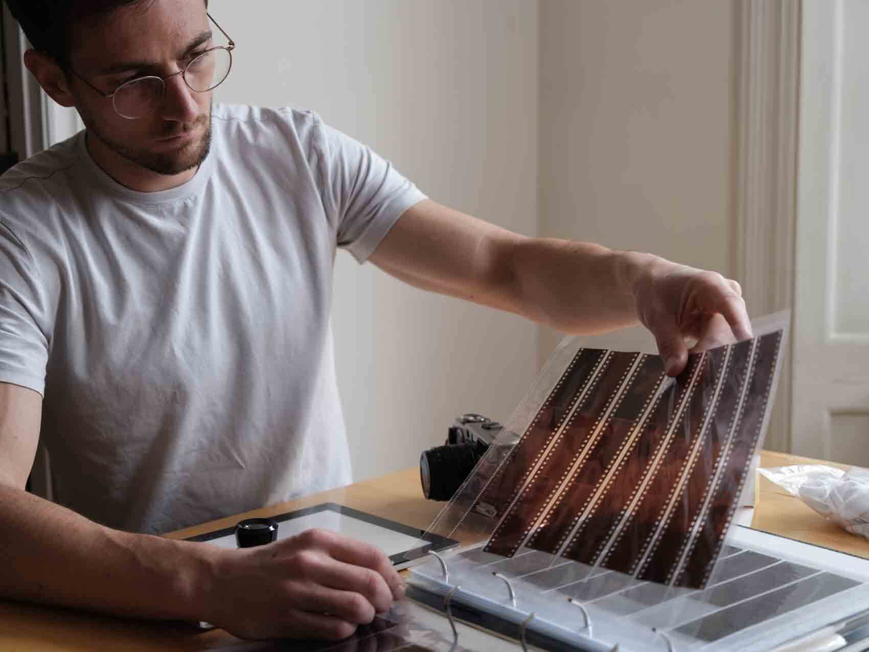 Film archival folder laying on a table with the photographer holding a page
