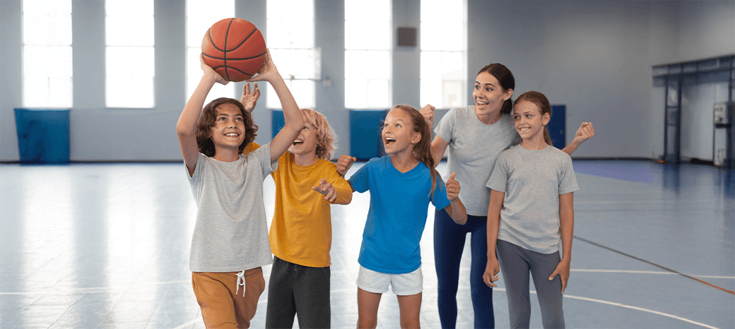 Young athletes practicing shooting and teamwork during a HOKALI school-based basketball enrichment program