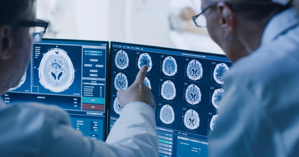 Doctors analyzing brain scans on advanced digital screens, representing Medicine 2.0—an era of evidence-based, technology-driven healthcare focused on diagnostics, pharmaceuticals, and standardized treatments.