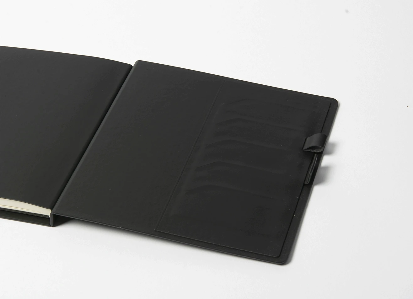 Detail view of black interior pockets and pen holder.