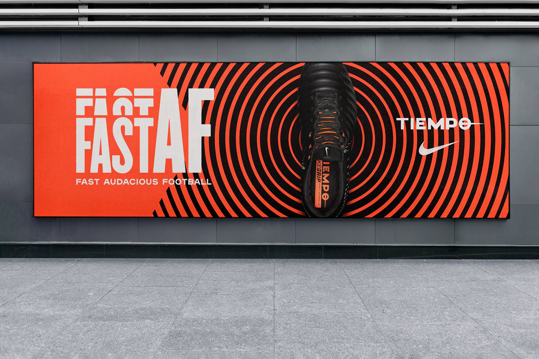 A subway advertising mockup with a high-energy orange and black graphic design.