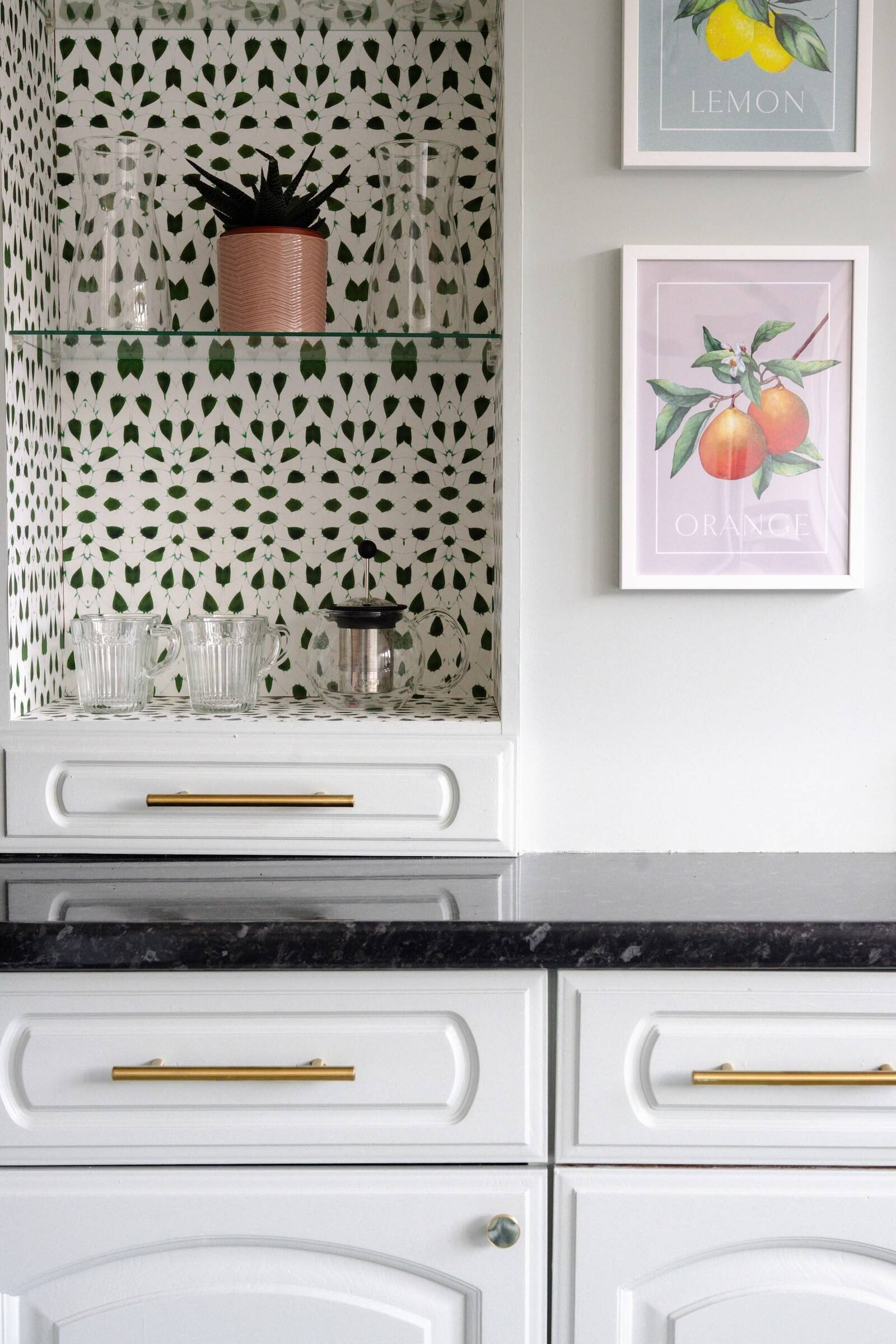 Bold Ottoline De Vries wallpaper revealed inside kitchen cabinets, turning hidden storage into a playful design feature by Atelier Akuko