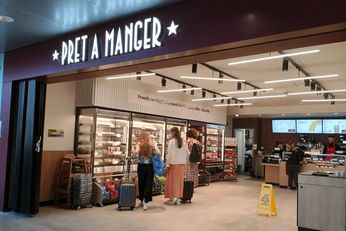 a starbucks coffee shop with a starbucks sign above the entrance