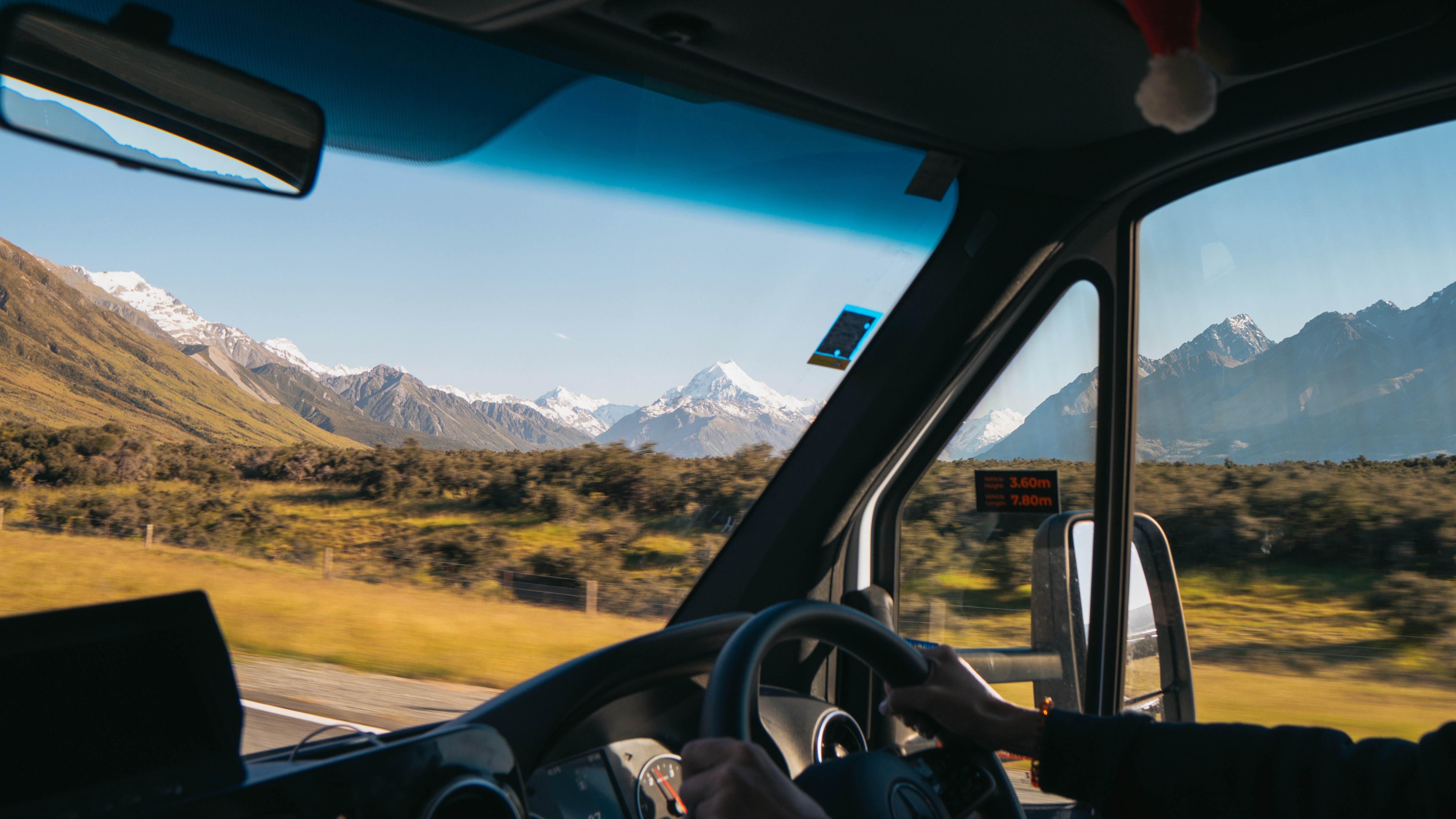 Portrait of a laughing person with curly hair wearing a white shirt