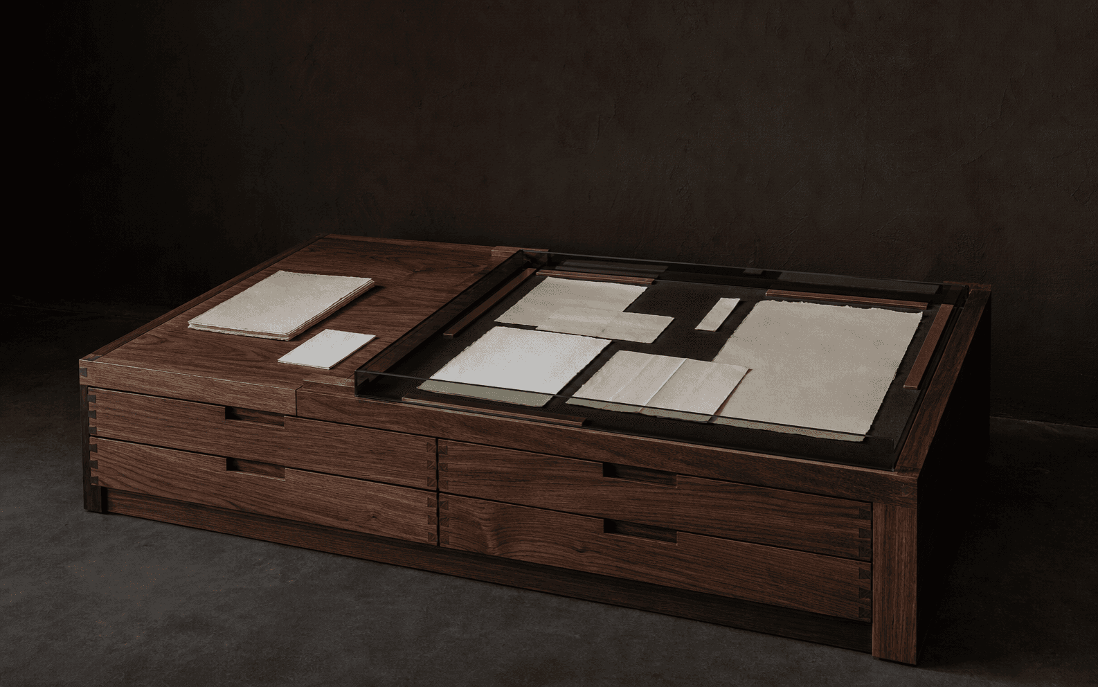 A reading table holds public records, editorial notes, and archival materials.