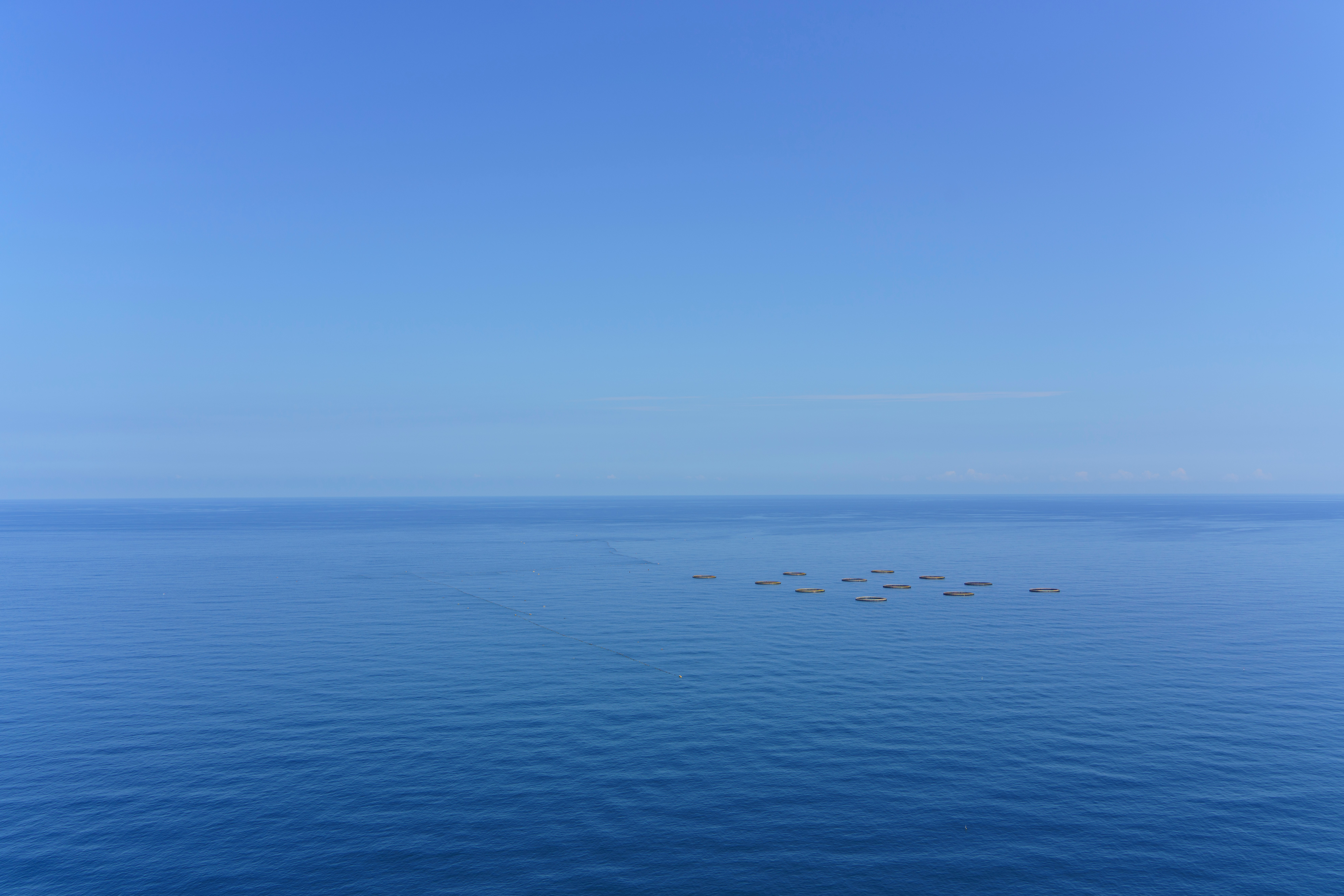 A large body of water with a sky background