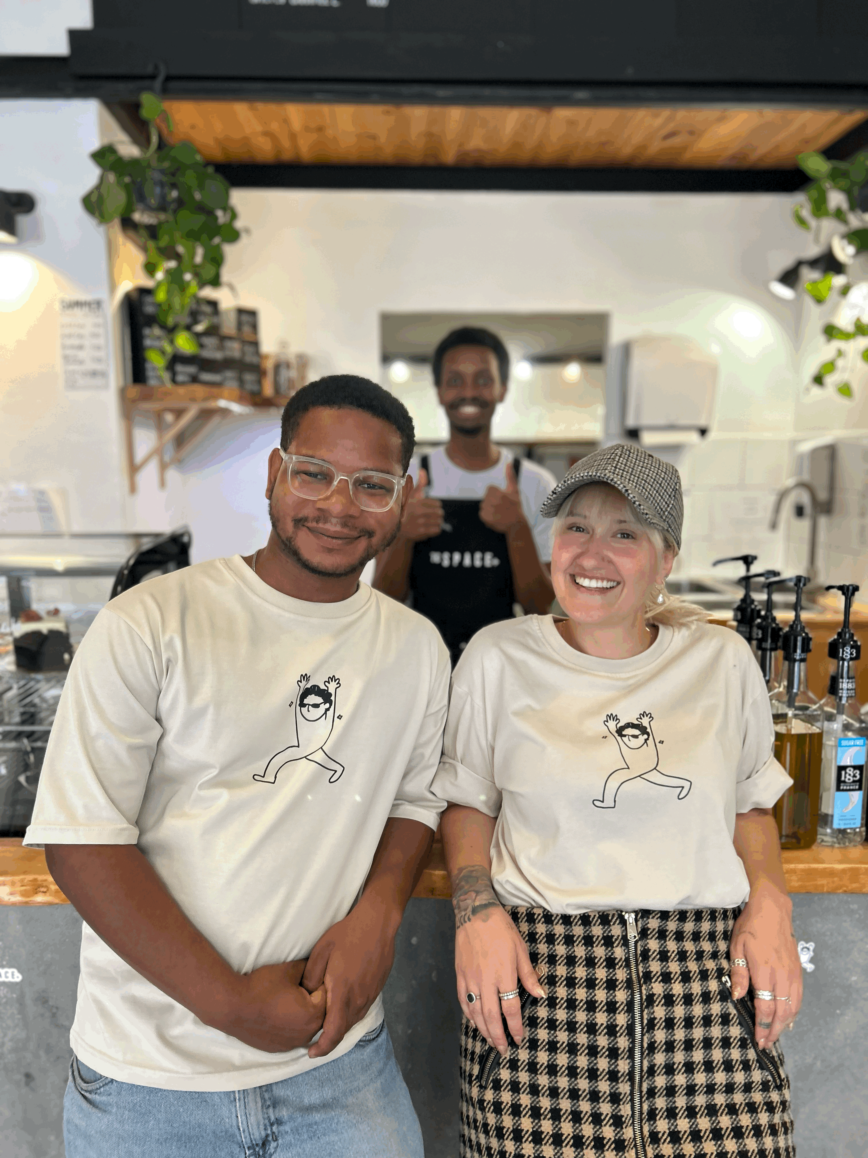Free Framer Template - A cozy interior of a cafe with wooden tables, chairs, and potted plants, creating a warm atmosphere.