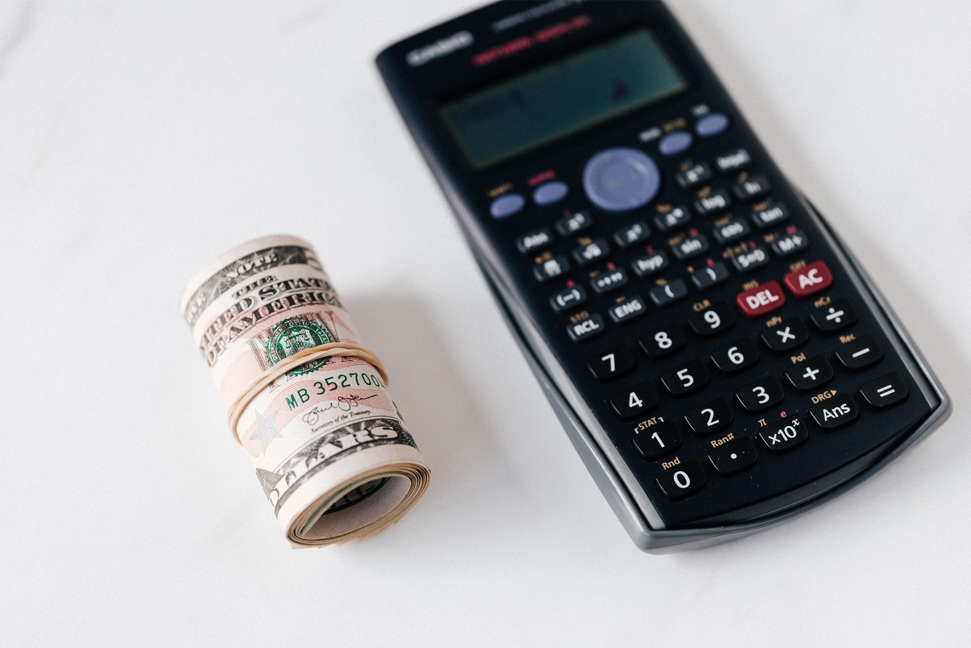 Calculator and cash representing data-driven strategies to increase website conversions and improve website conversions through CRO.
