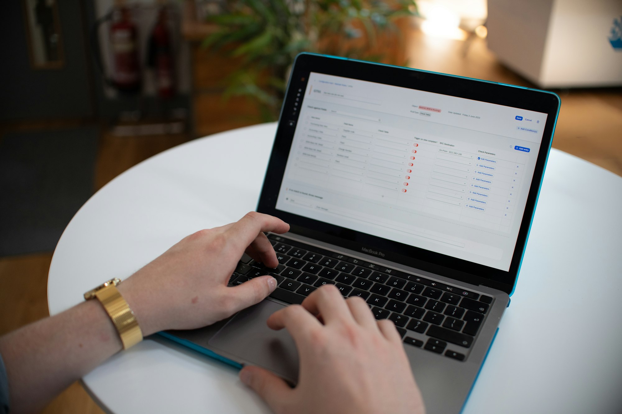 Hands on a laptop showing a spreadsheet, the default angel book a tracker is meant to replace