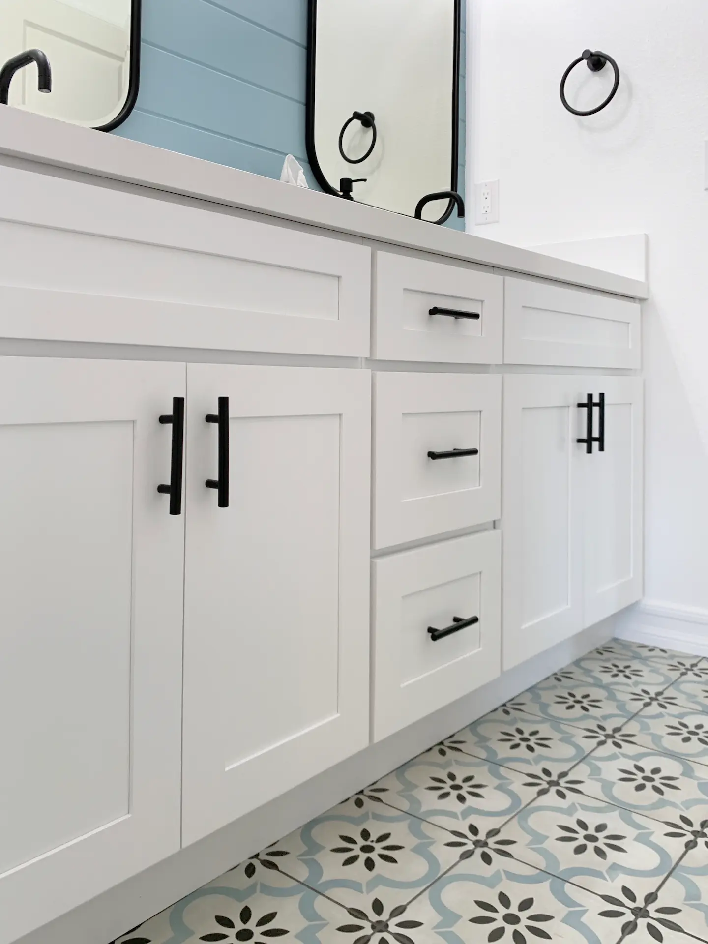 Close up of the kid's bath vanity cabinetry, highlighting the shaker style doors and black hardware in the Ladera Ranch home. Photo by Todd Huge.