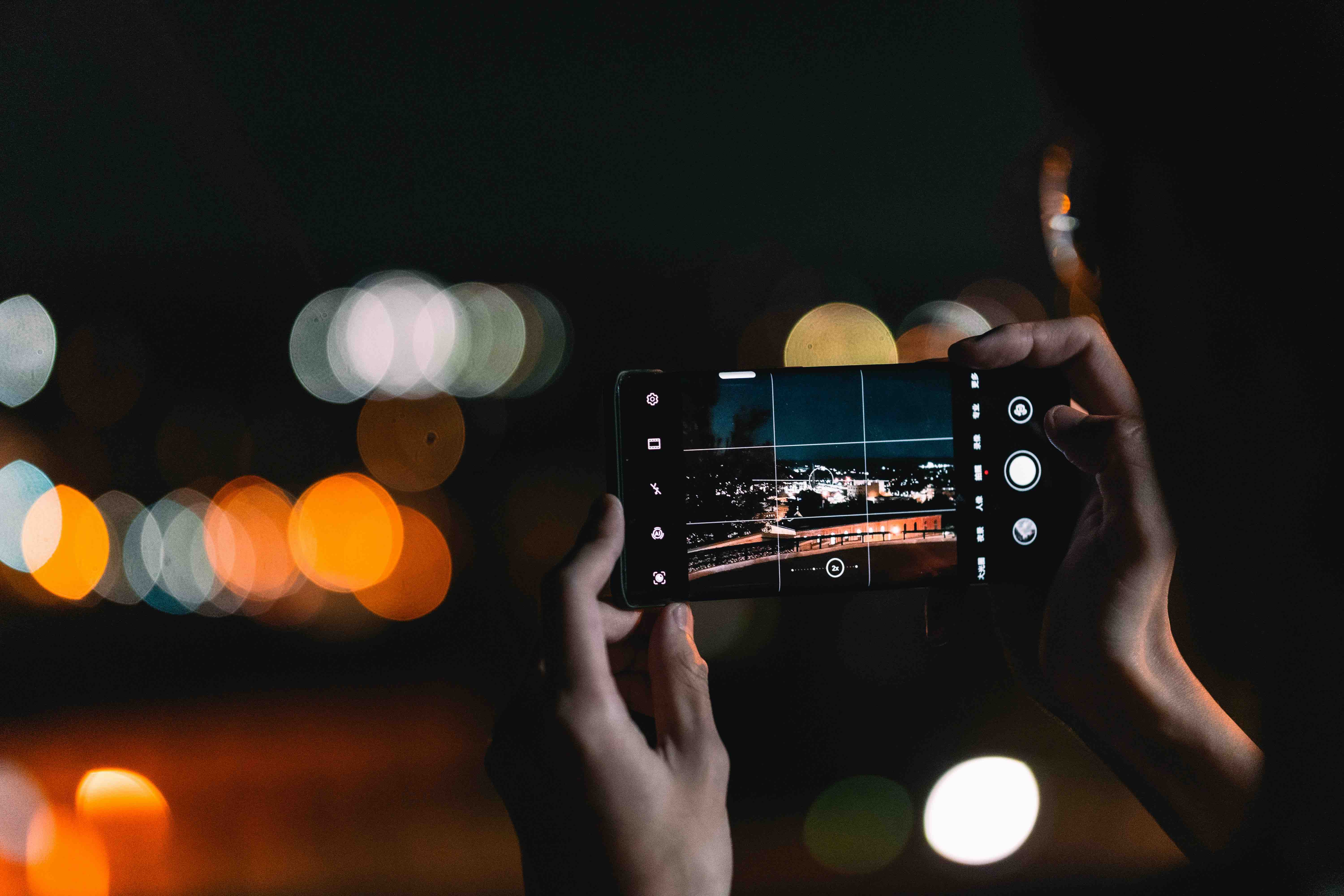 A person taking a picture at night using an Android phone