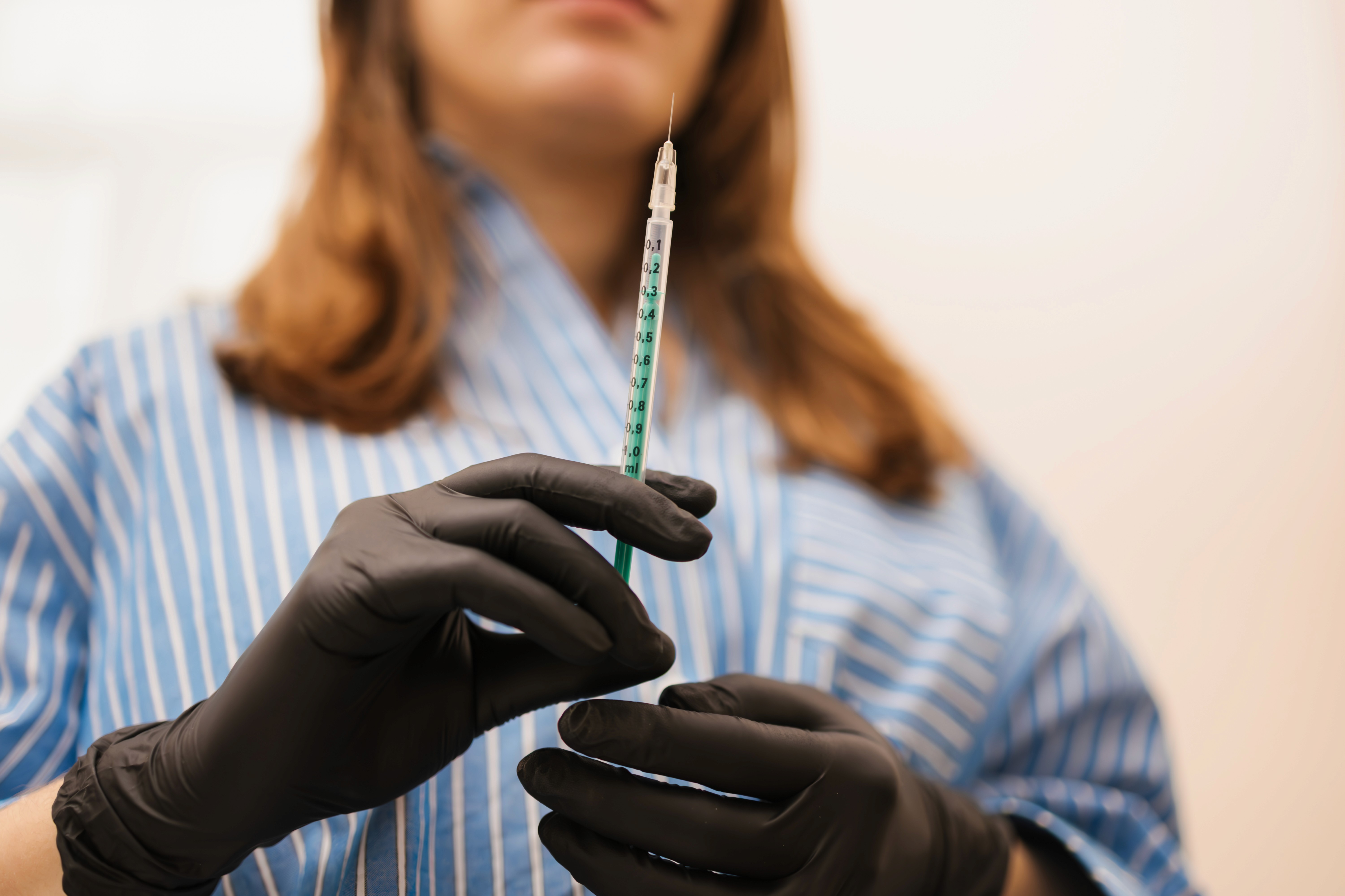 Dr. Louise Cuveele holding a Botox syringe.