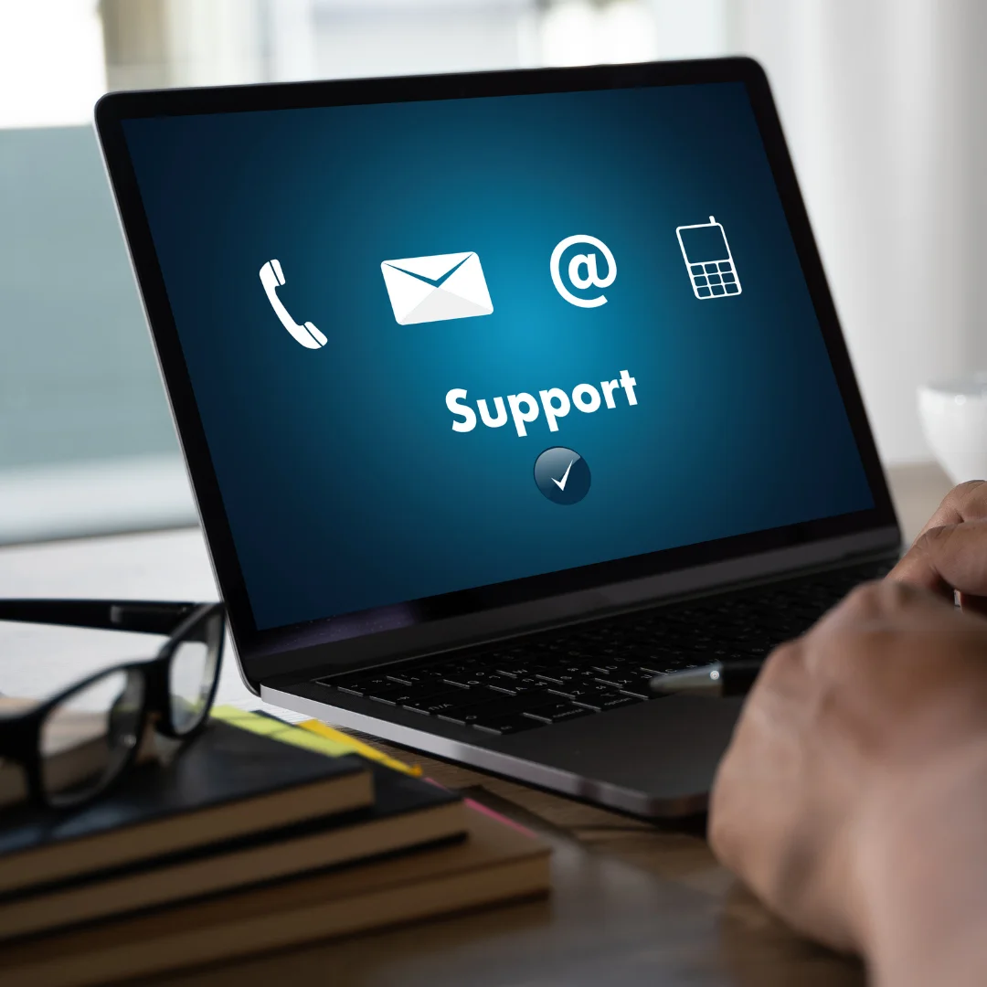 Person using a laptop displaying IT support contact options