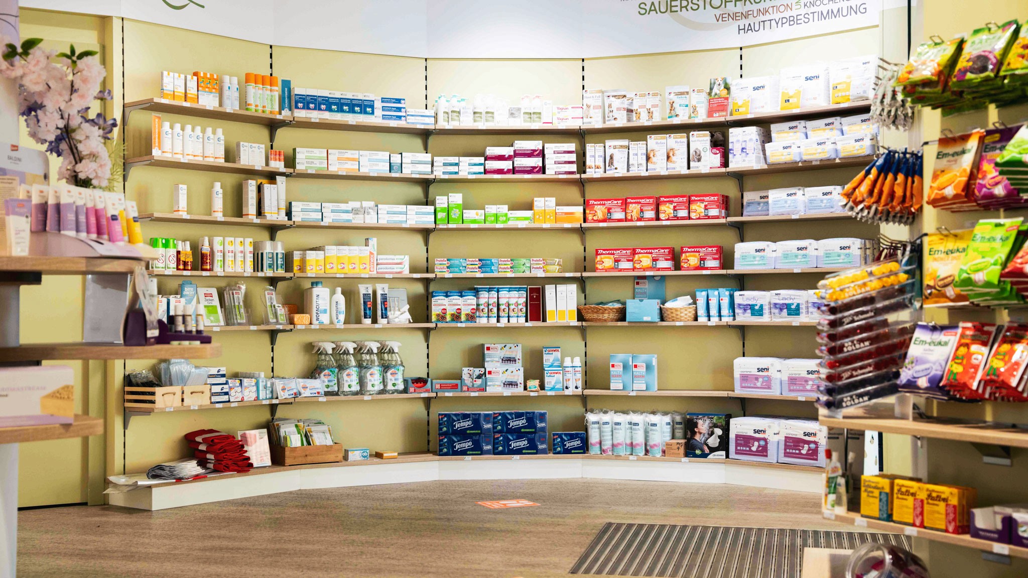 Übersichtlich sortierte Gesundheitsprodukte in einem Apothekenregal. Die Healthcare-Branche setzt auf Vertrauen, Präzision und klare Produktpräsentation im Verkaufsraum.