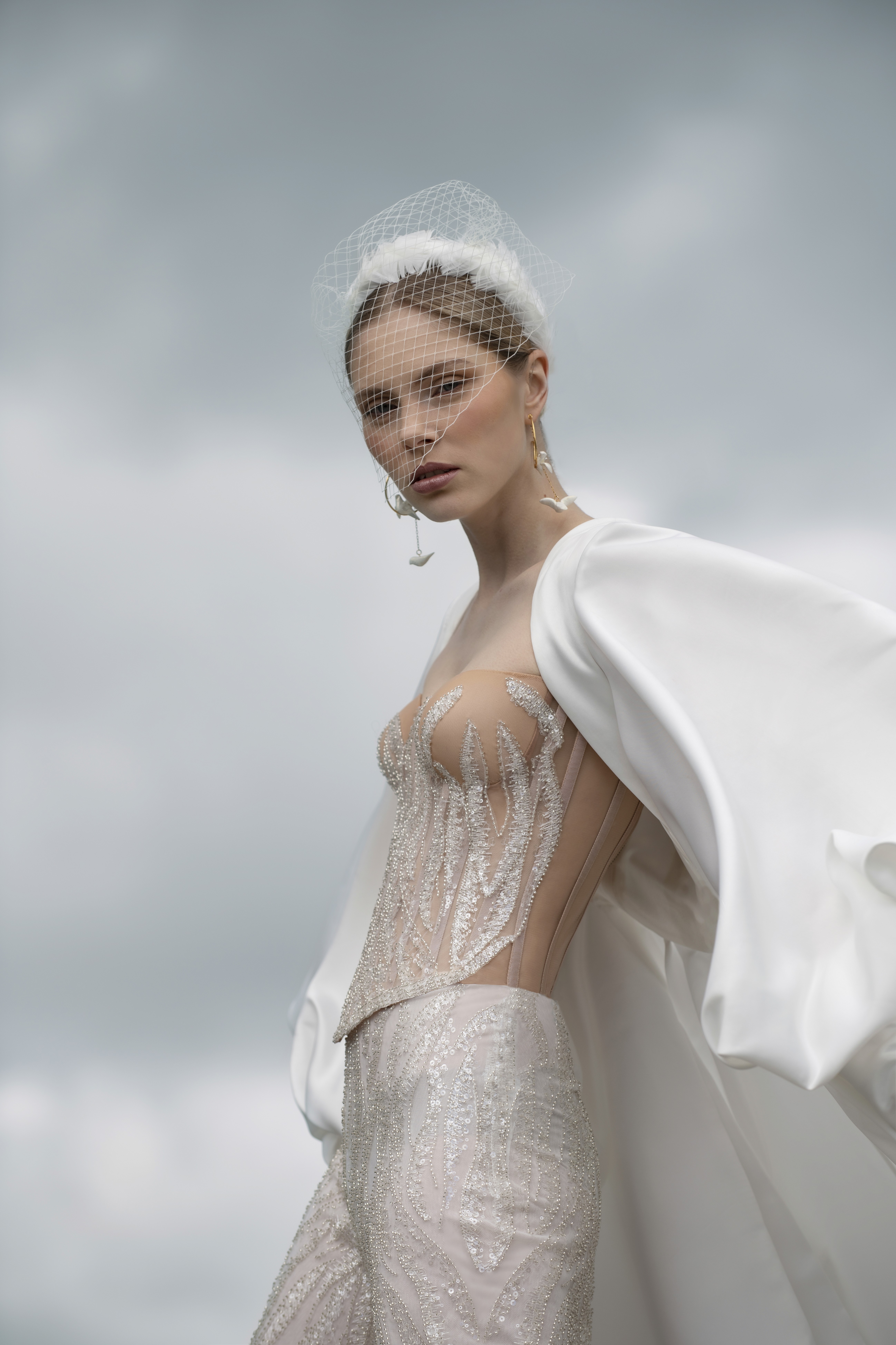 Bold editorial fashion portrait of model in houndstooth blazer with red tie and green shirt against bright turquoise background - Serif Creative Studio luxury fashion photography