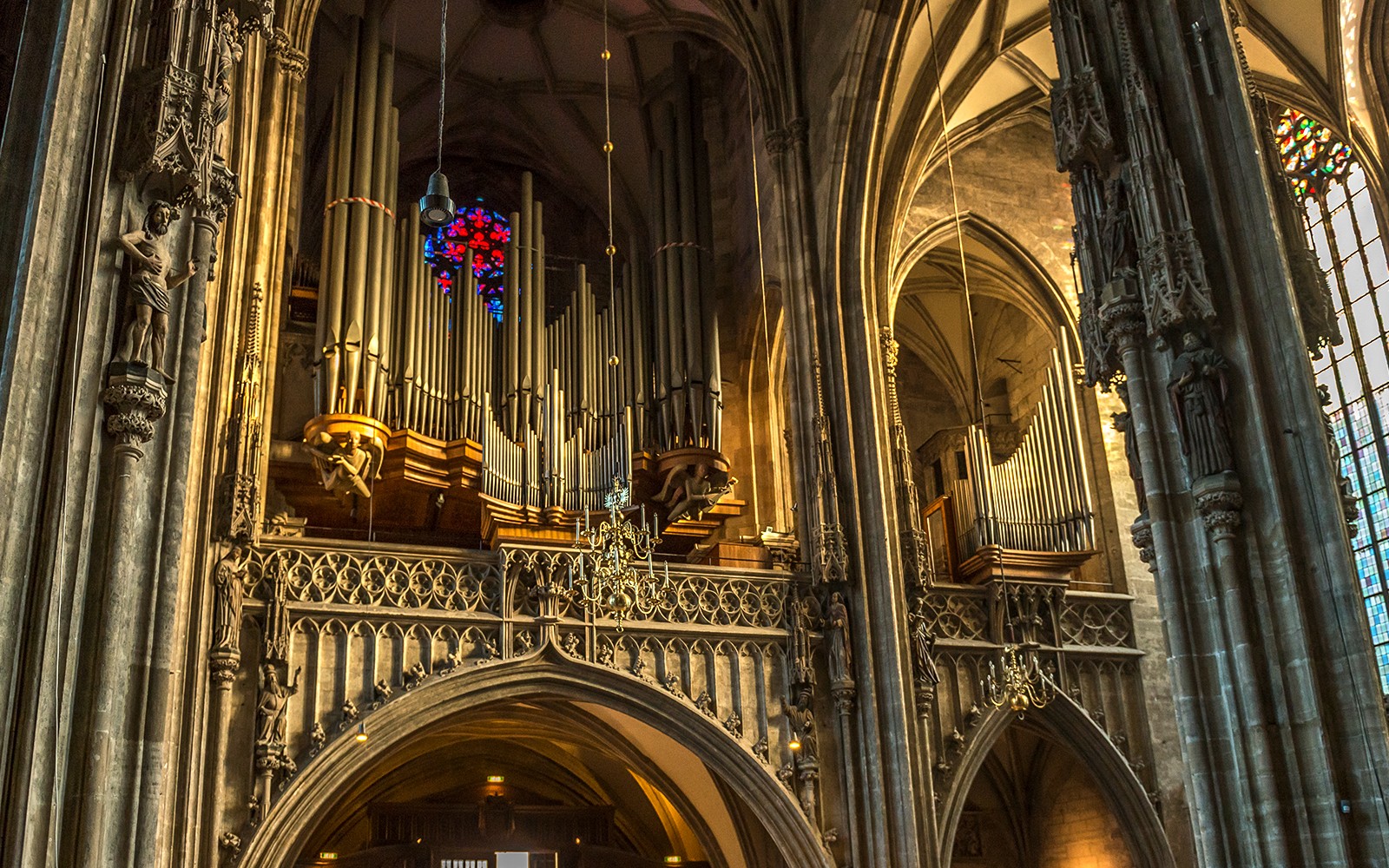 St. Stephen's Cathedral organ pipes and stained glass window in Vienna.