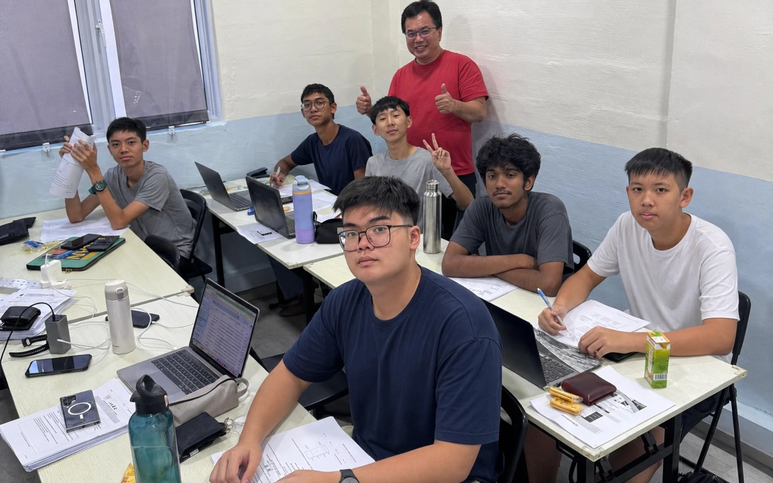Mr Isaiah Low with his students