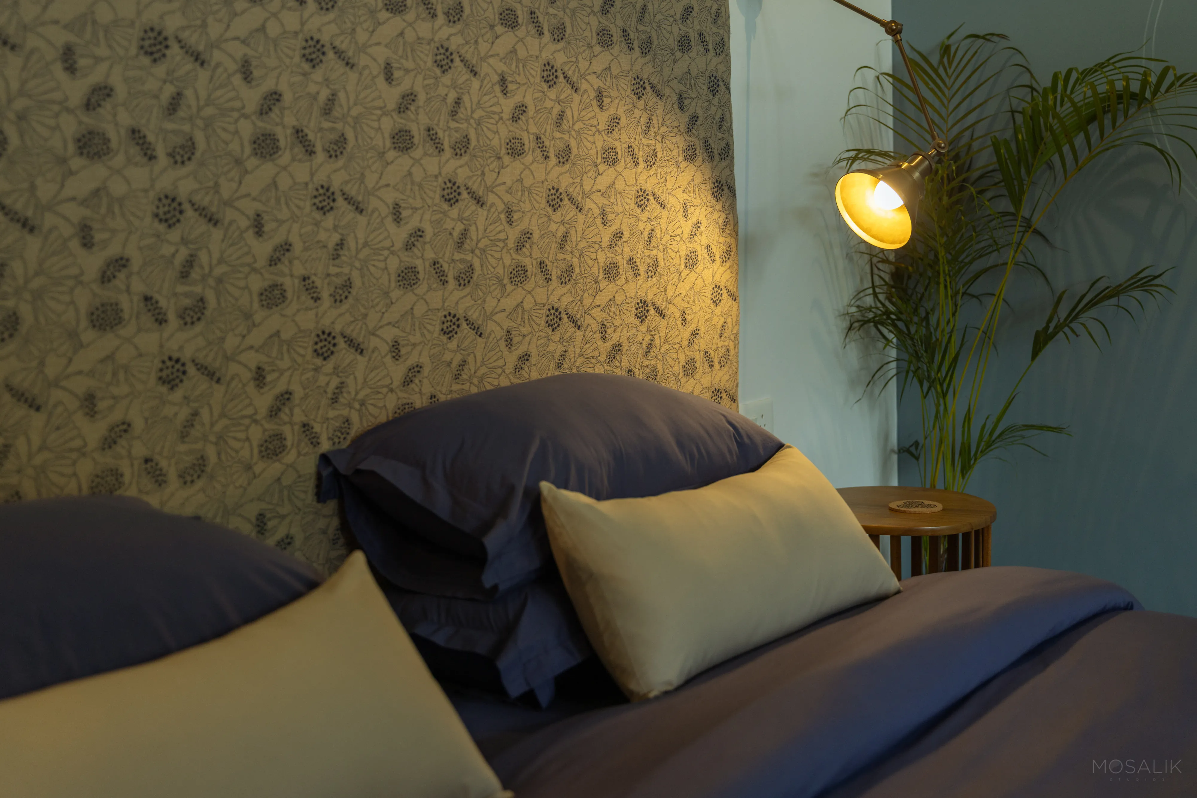 Botanical wallpaper behind the bed at Jaali Blue