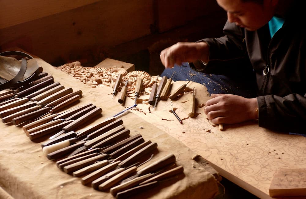 Carpenter carving out wood