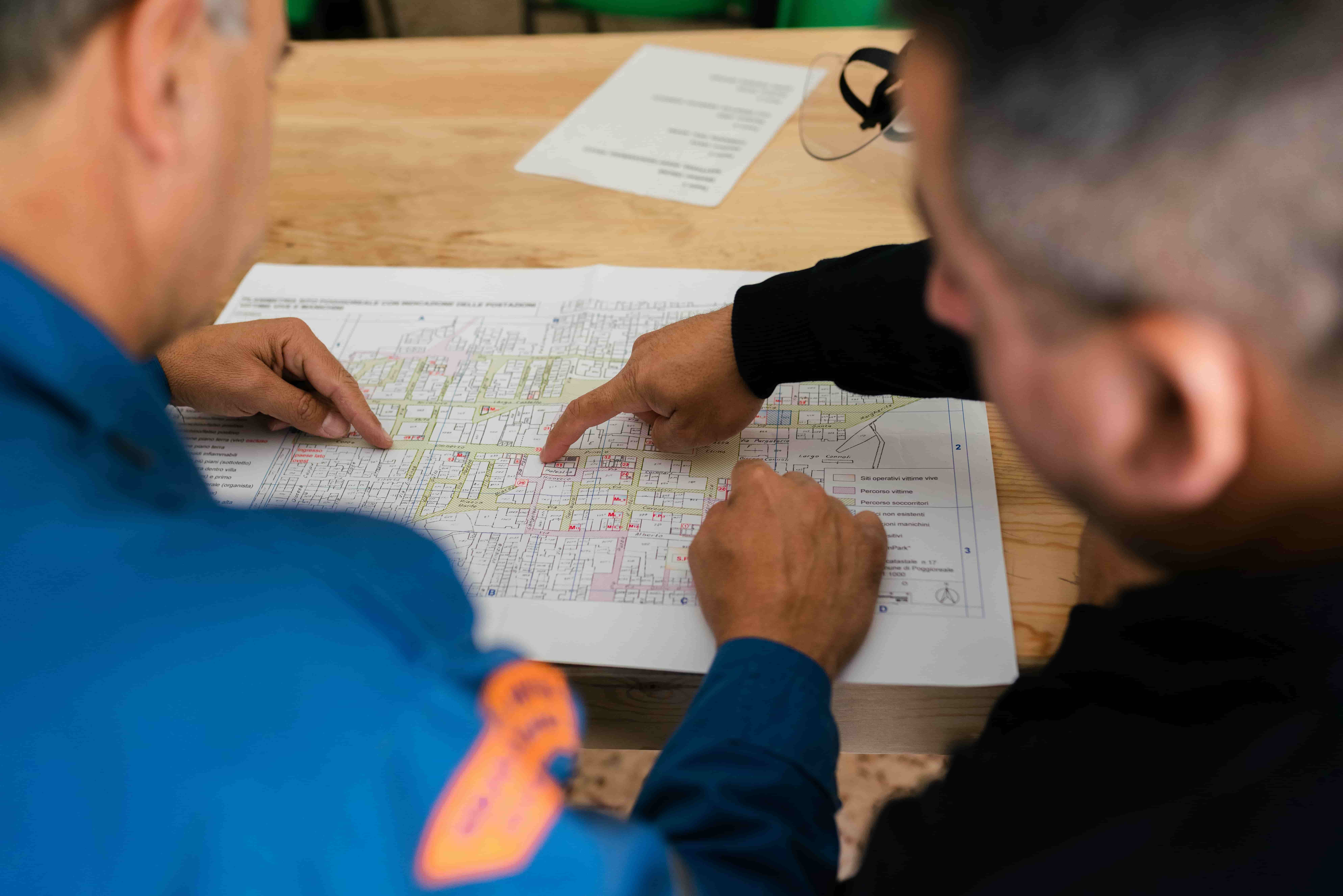 Engineers reviewing technical drawings and plans, representing specification development and project planning