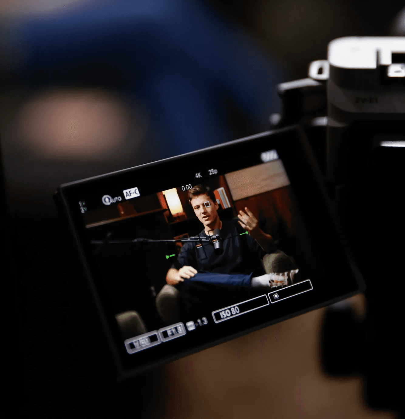 A camera monitor showing a guest being filmed during a video podcast recording