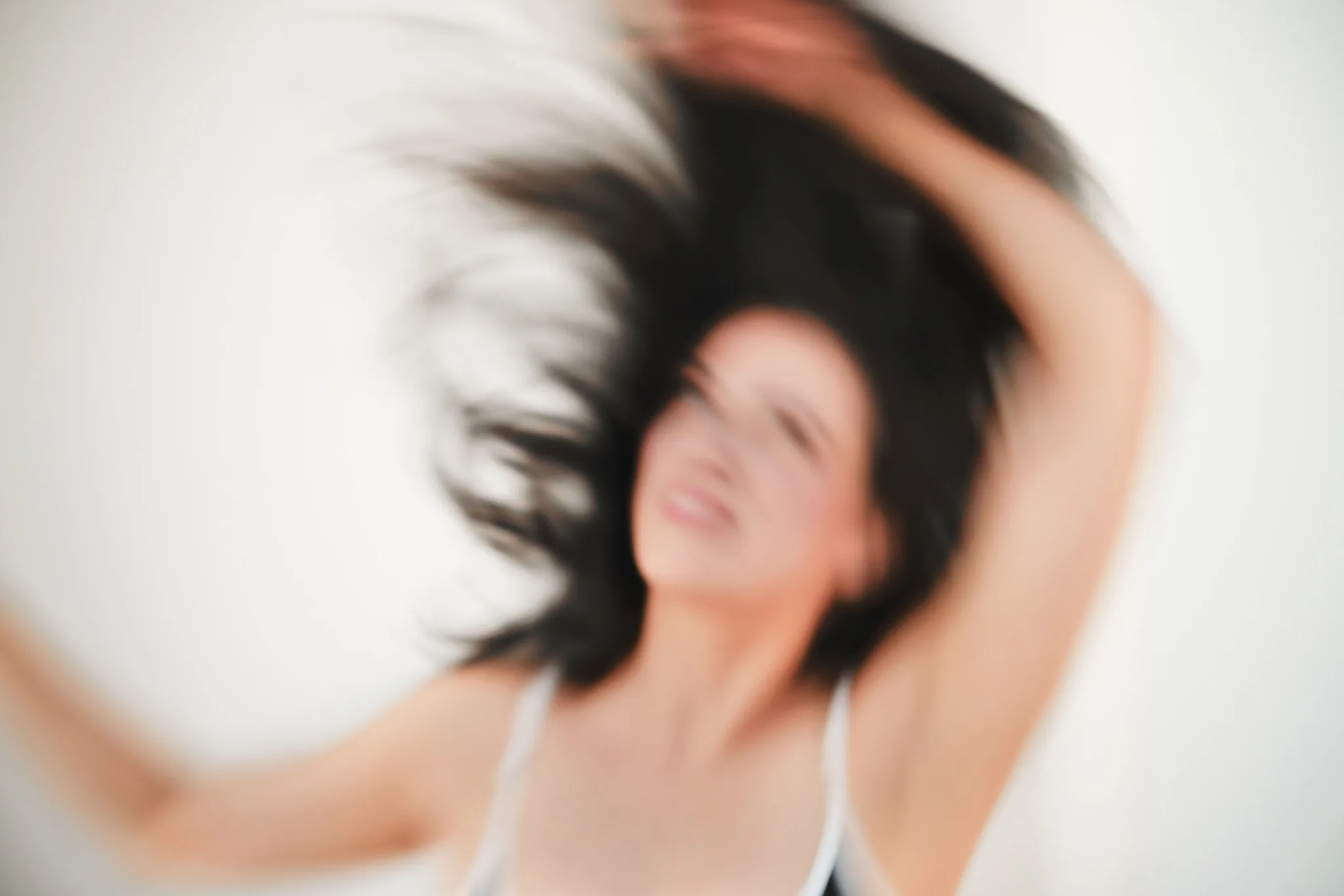 woman whipping hair mid motion — portrait photography by Tom Kubik