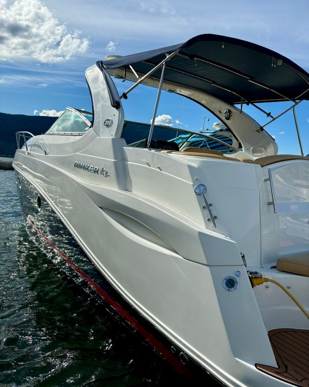 A clean cabin cruiser parked in the water