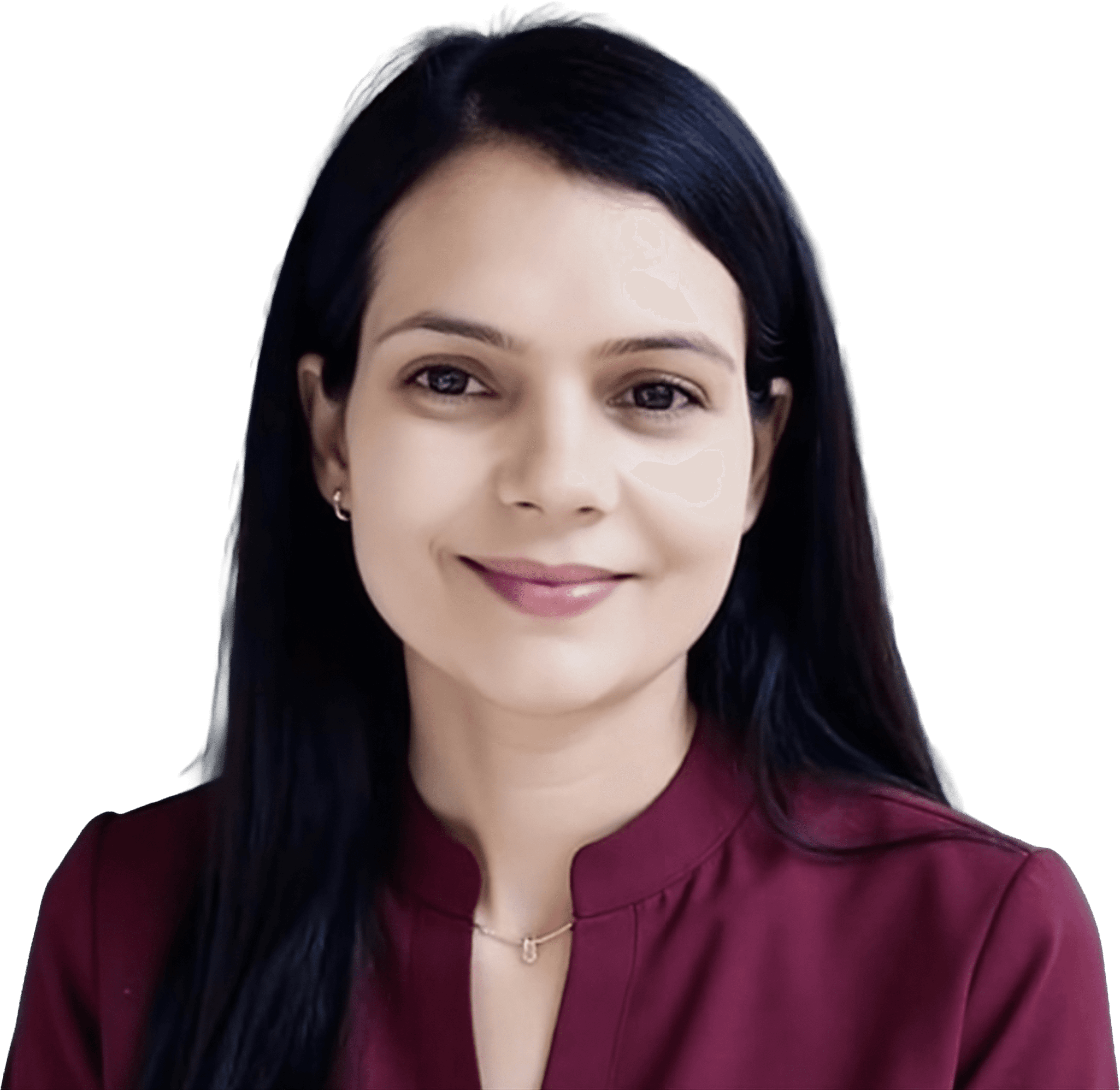 Smiling female therapist with short gray hair, wearing a brown top and a purple shawl, surrounded by a cozy background.