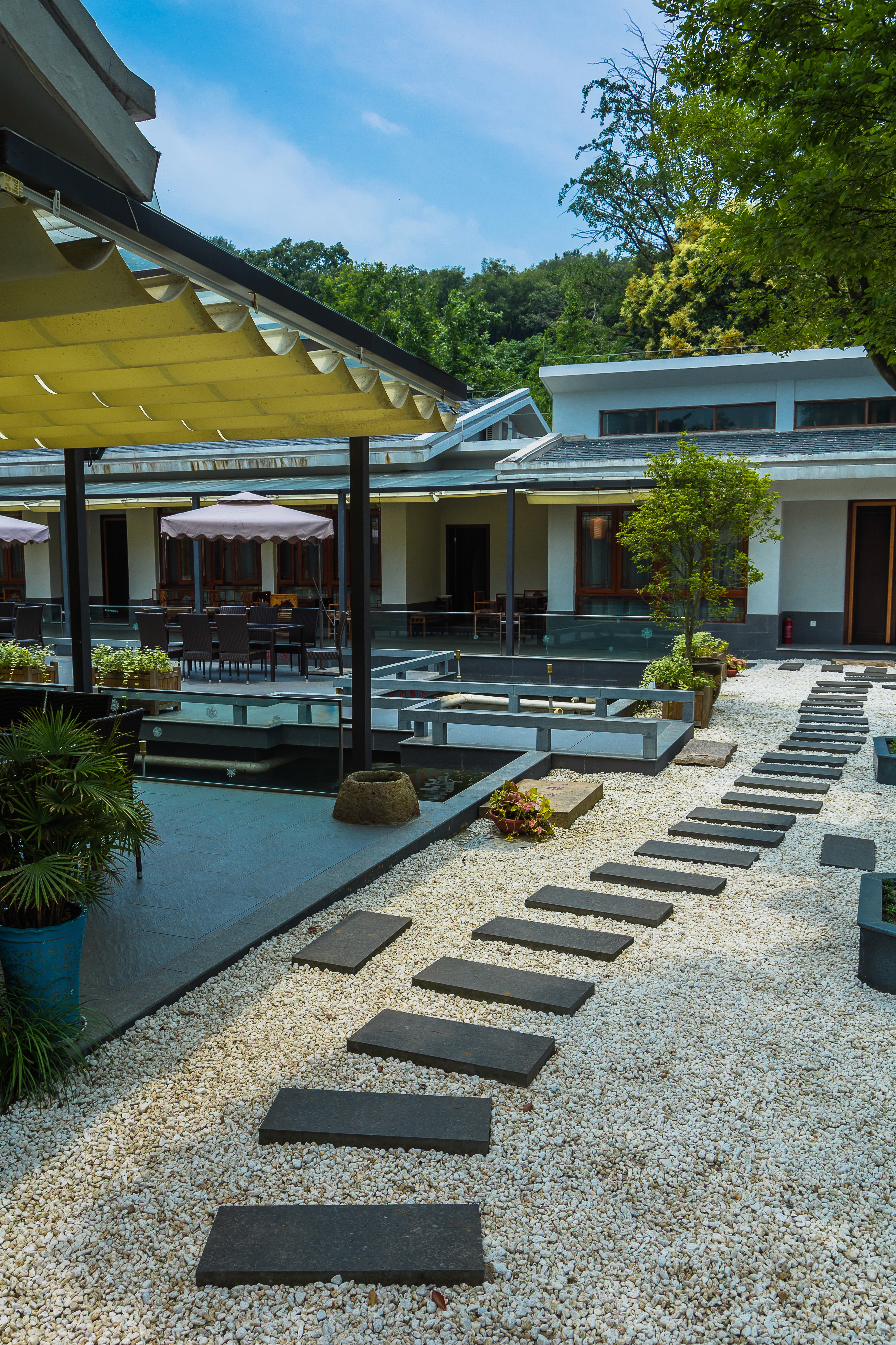 Suburban residential units with modern stone exteriors, landscaped gardens, and walking paths