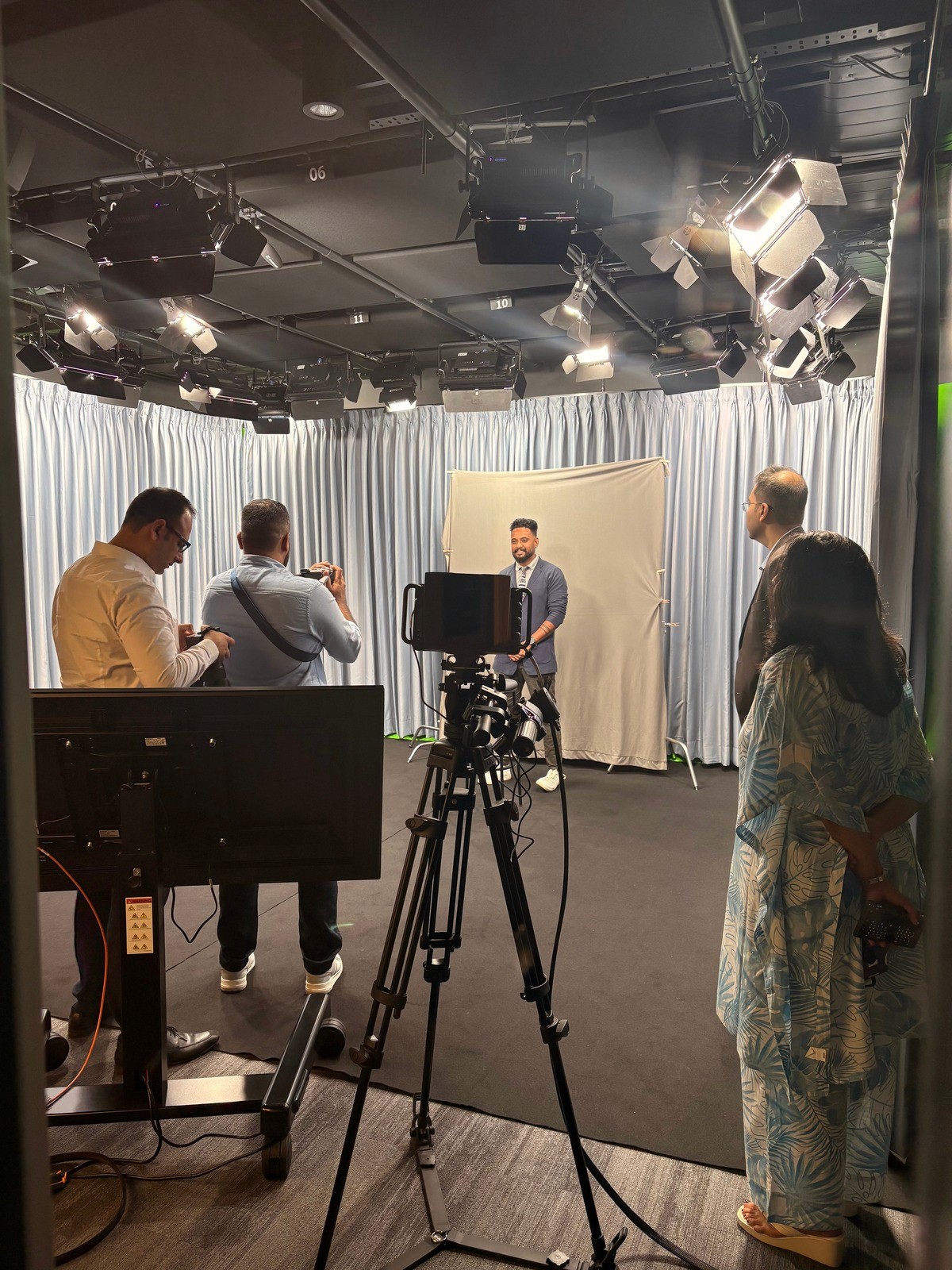 Blurry black-and-white figure in cap, white shirt, and black trousers.