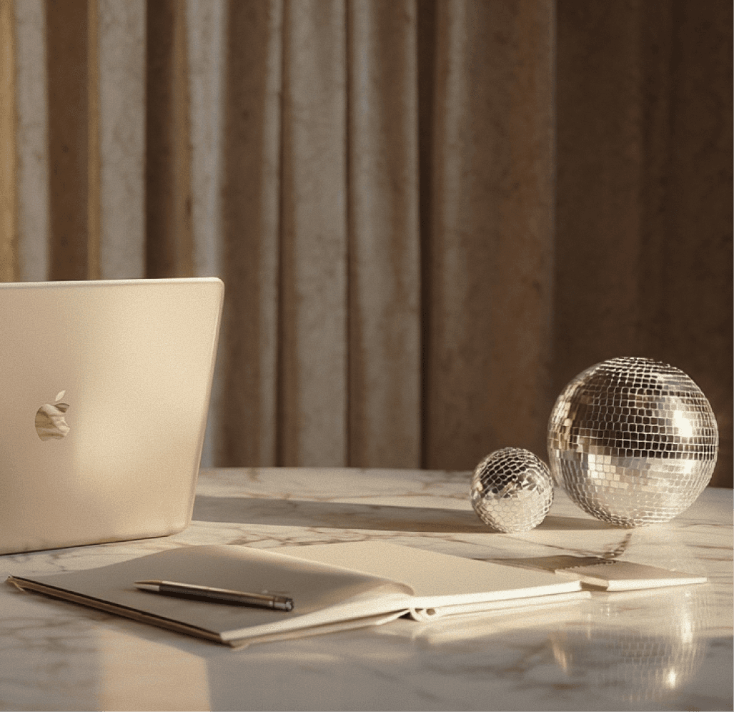 A laptop and a colorful ball are placed on a wooden table, showcasing a casual workspace setting.