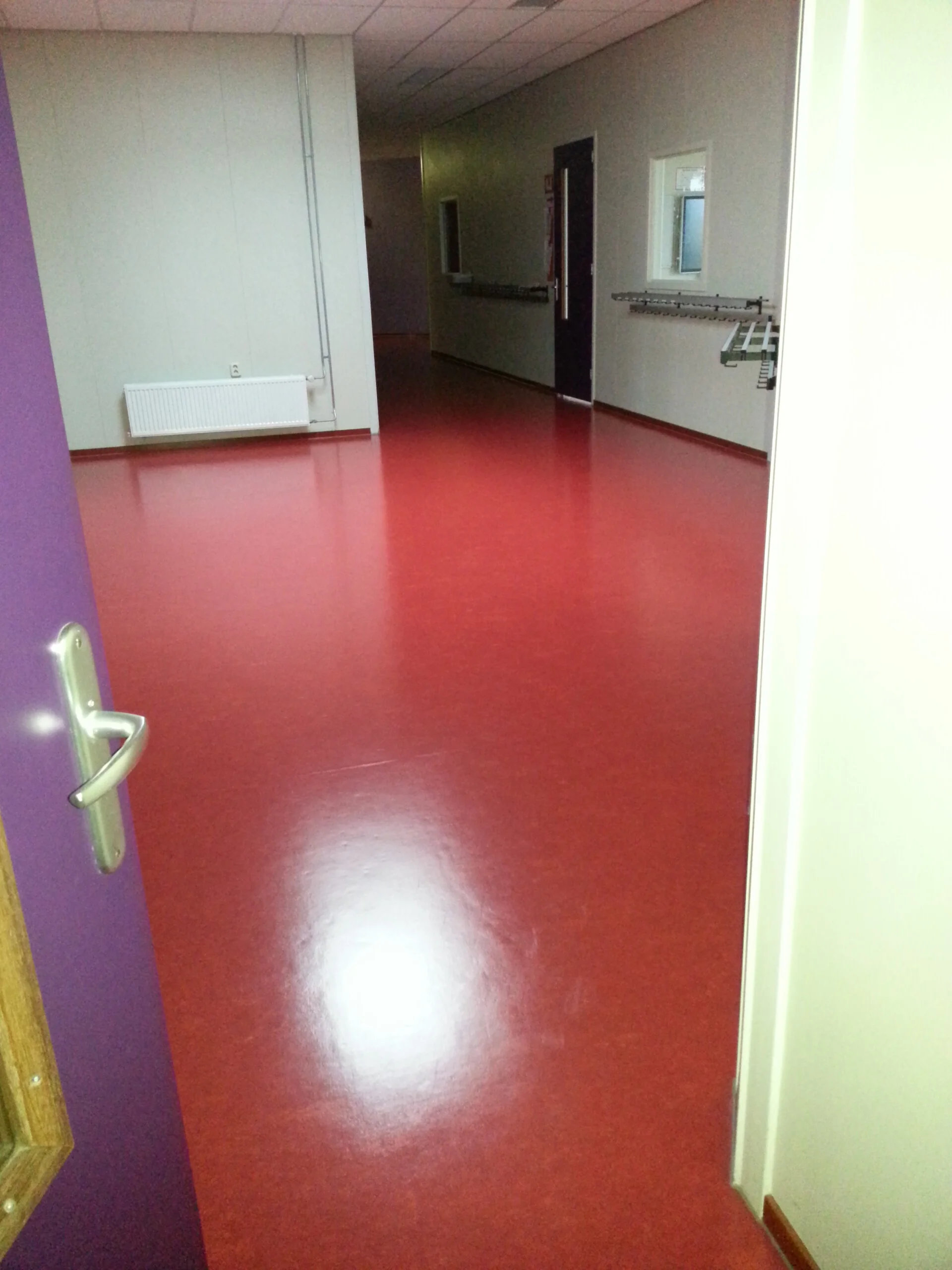 A diverse team collaborates around a table, analyzing documents and charts in a professional setting with a light green background.
