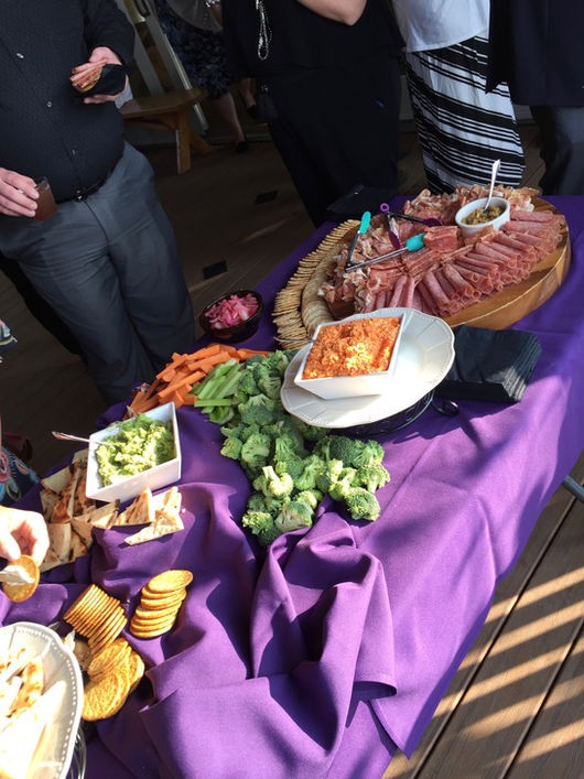 Charcuterie and veggie spread on a purple tablecloth at Camp Lenox