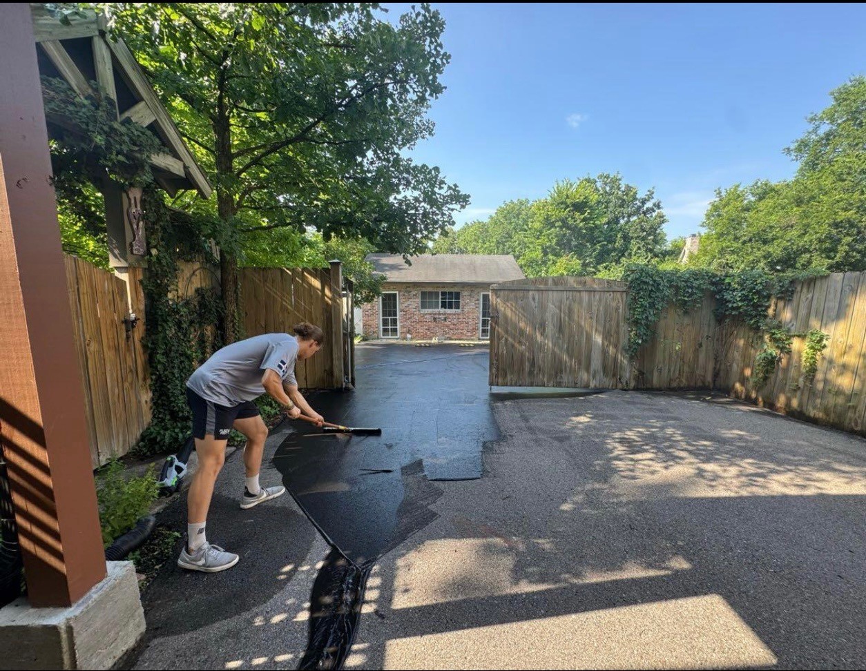 Settle Solutions' crew sealing driveway