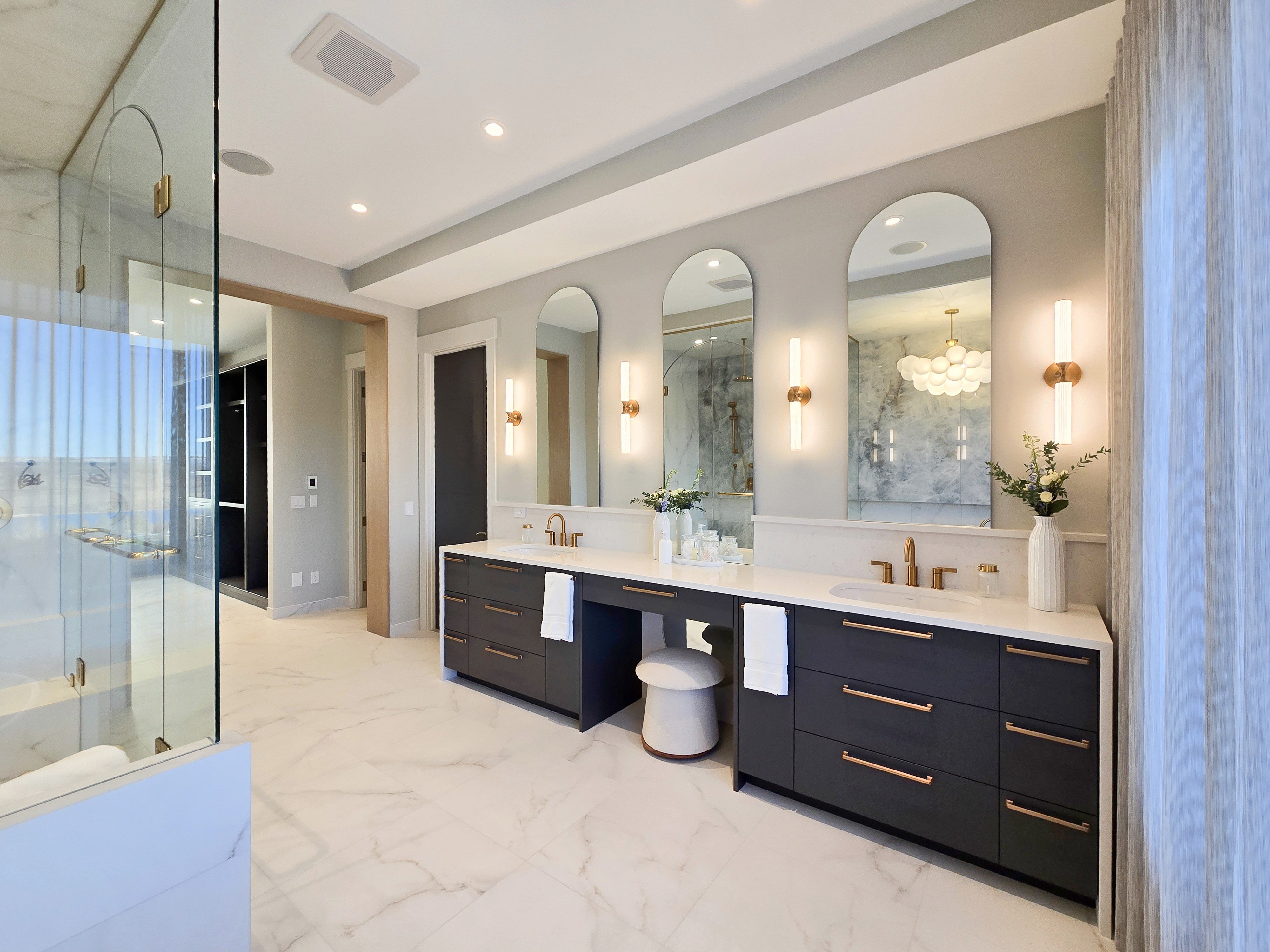 Image of Luxurious primary ensuite bathroom with dual sink vanity and spacious marble shower by KHD Homes.