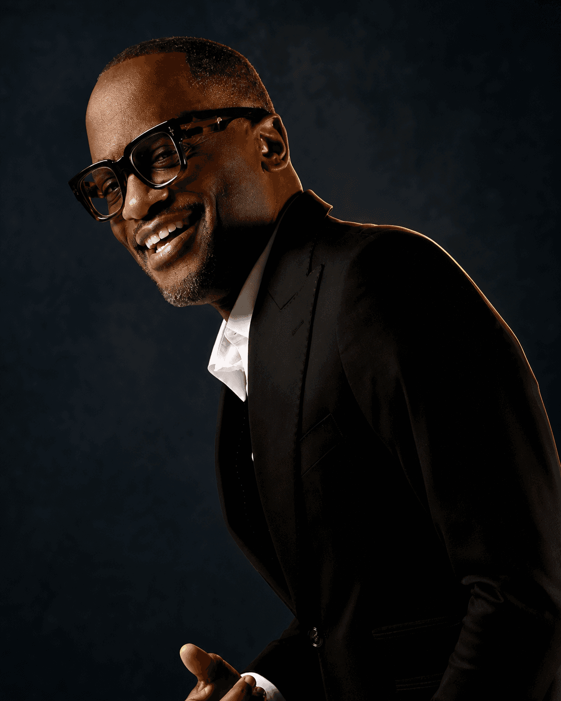 Dr. Glenn Toby smiling in a black suit