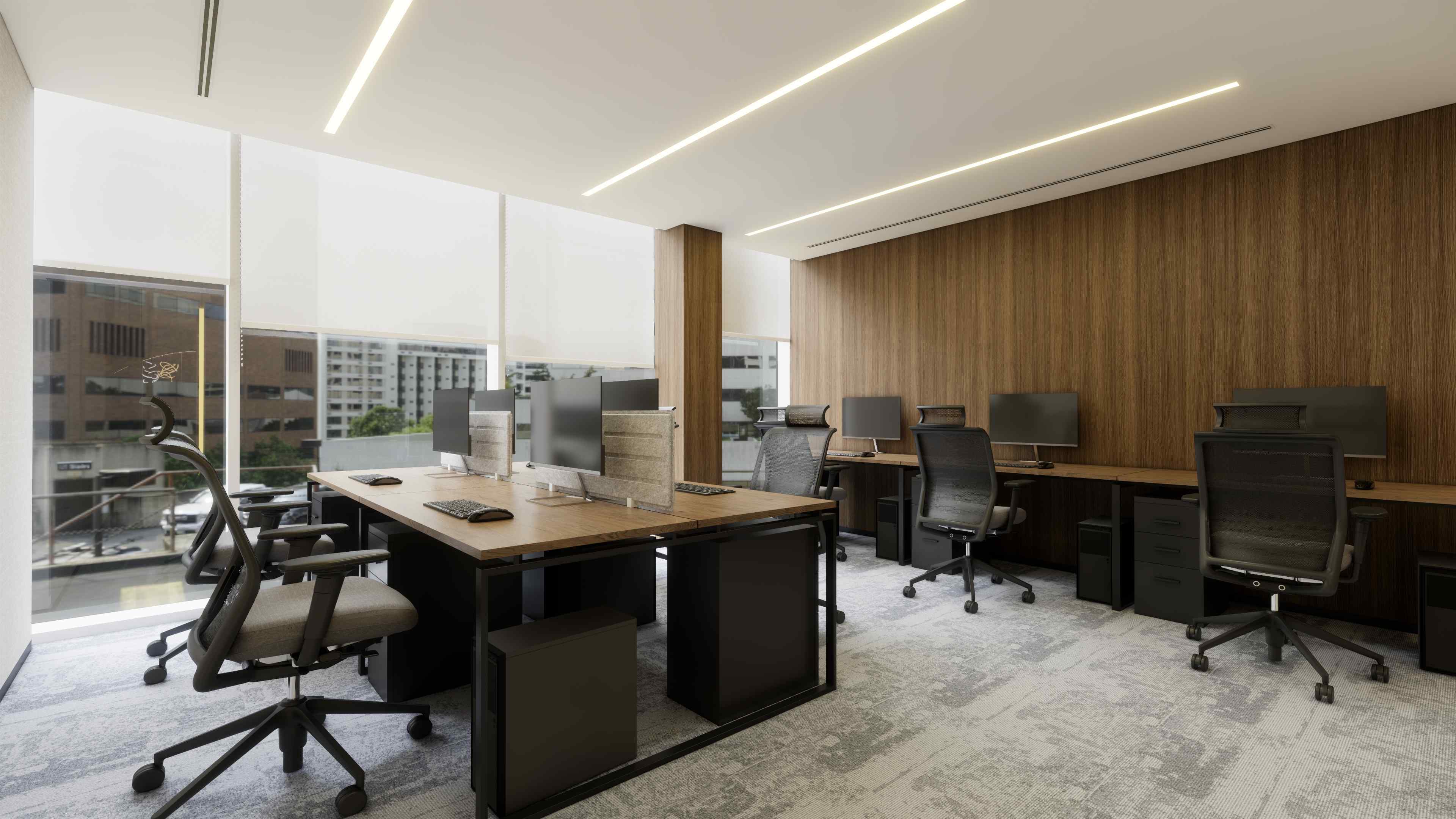 Bright private office setup with multiple desks, ergonomic chairs, large windows, and wood-paneled walls.